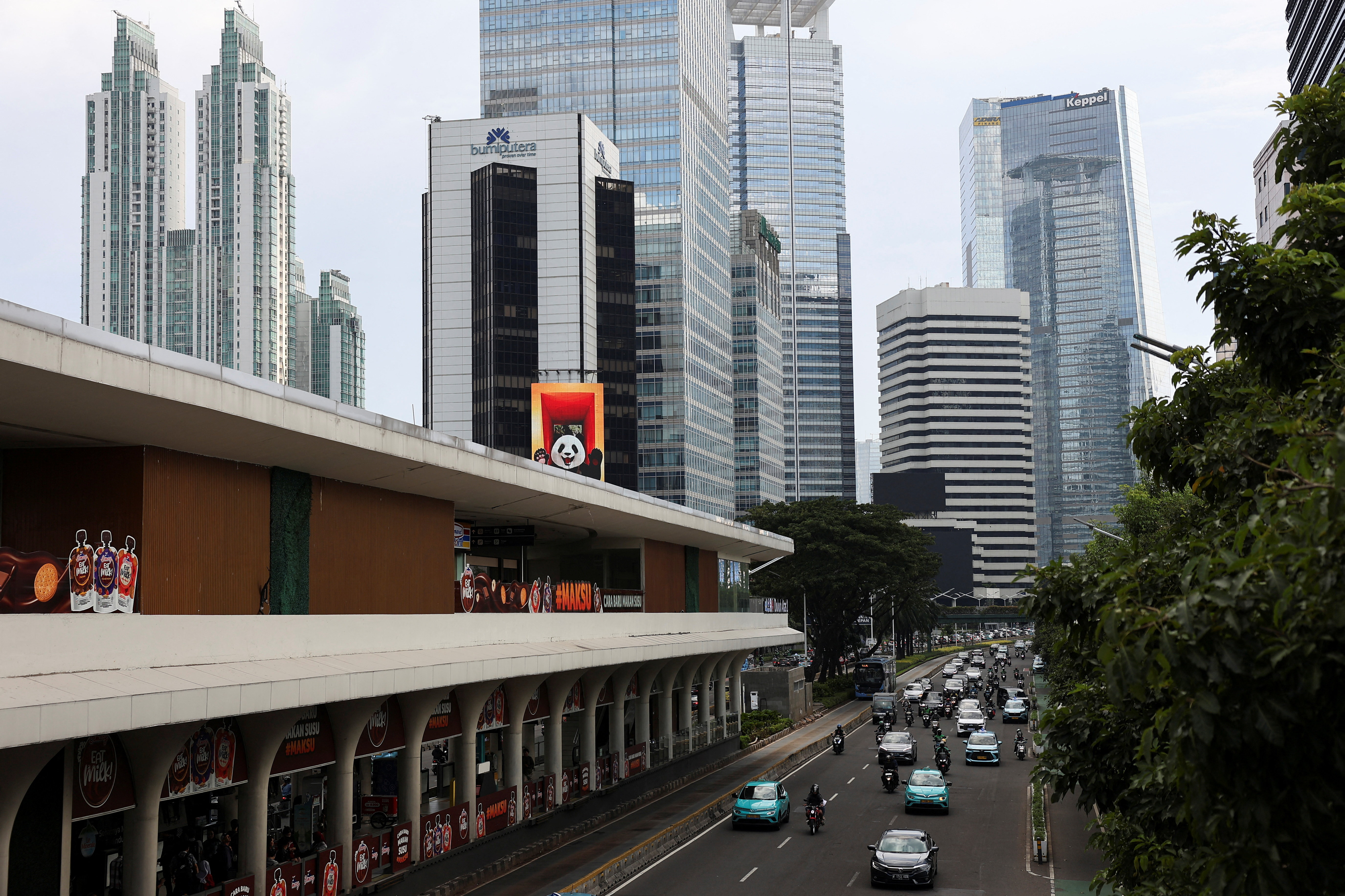 Vehicles drive past Jakarta’s business district
