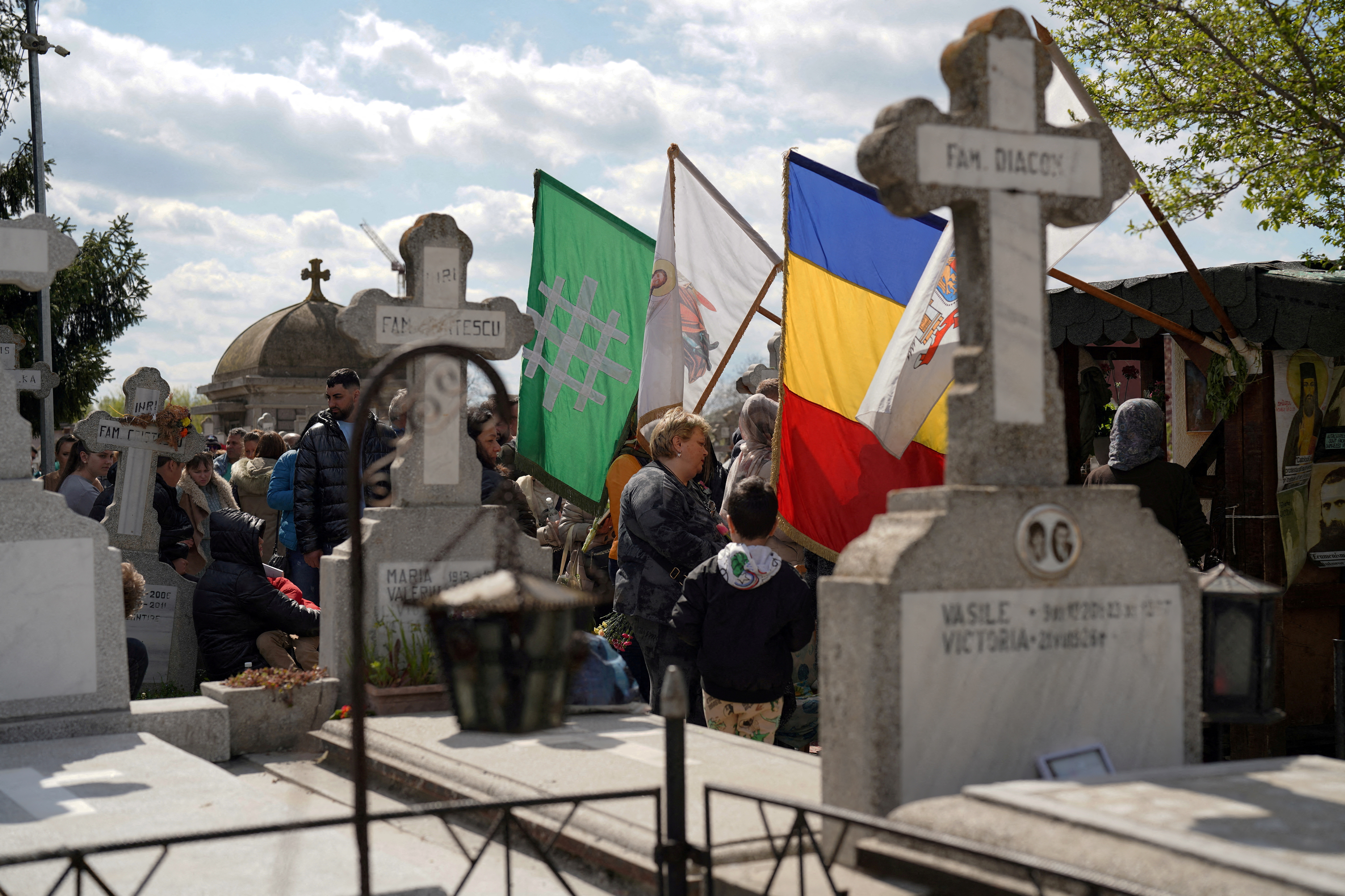 FILE PHOTO: People queue up at a tomb bearing the flag with the insignia of the Iron Guard, in Bucharest