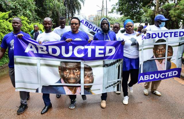 Ugandan politicians and supporters of opposition leader Kizza Besigye, who was abducted in neighbouring Kenya on November 16, march to the Kenya High Commission in Uganda, in Kampala