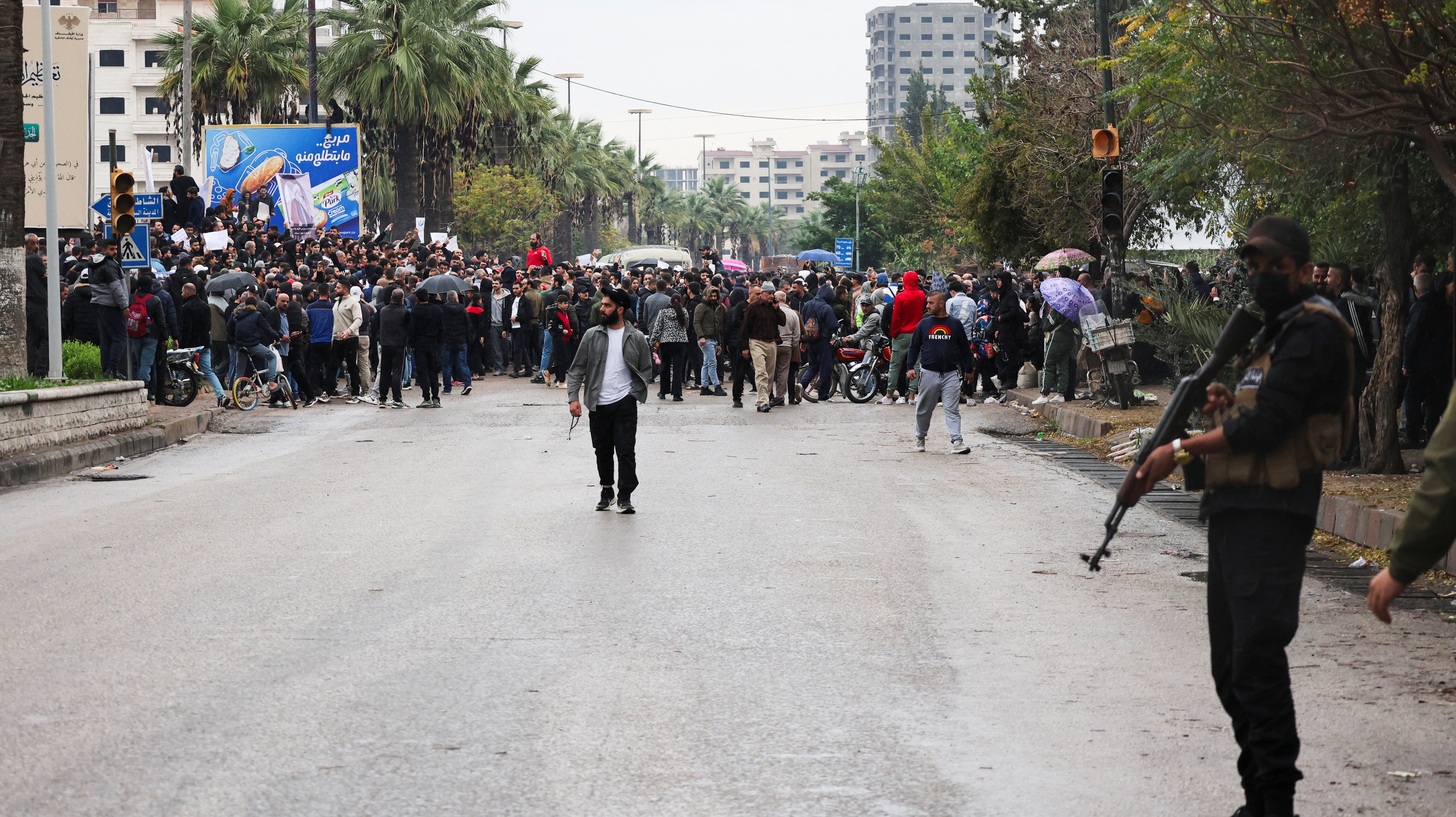 Alawites gather during a protest to demand federalism and the release of detained members of their community, in Latakia