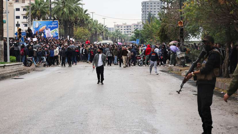 Alawites gather during a protest to demand federalism and the release of detained members of their community, in Latakia