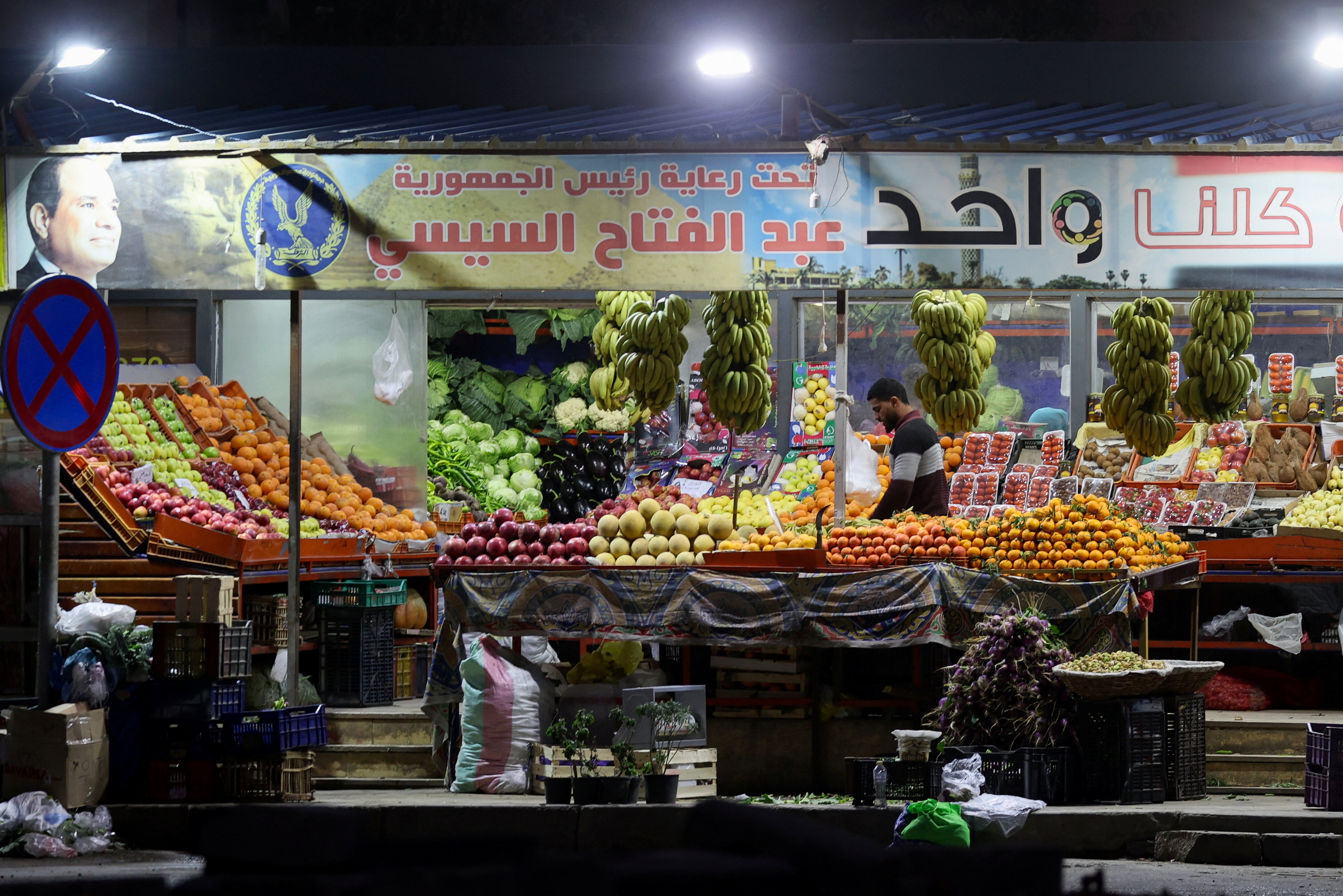Egyptians buy food in a popular market in Cairo
