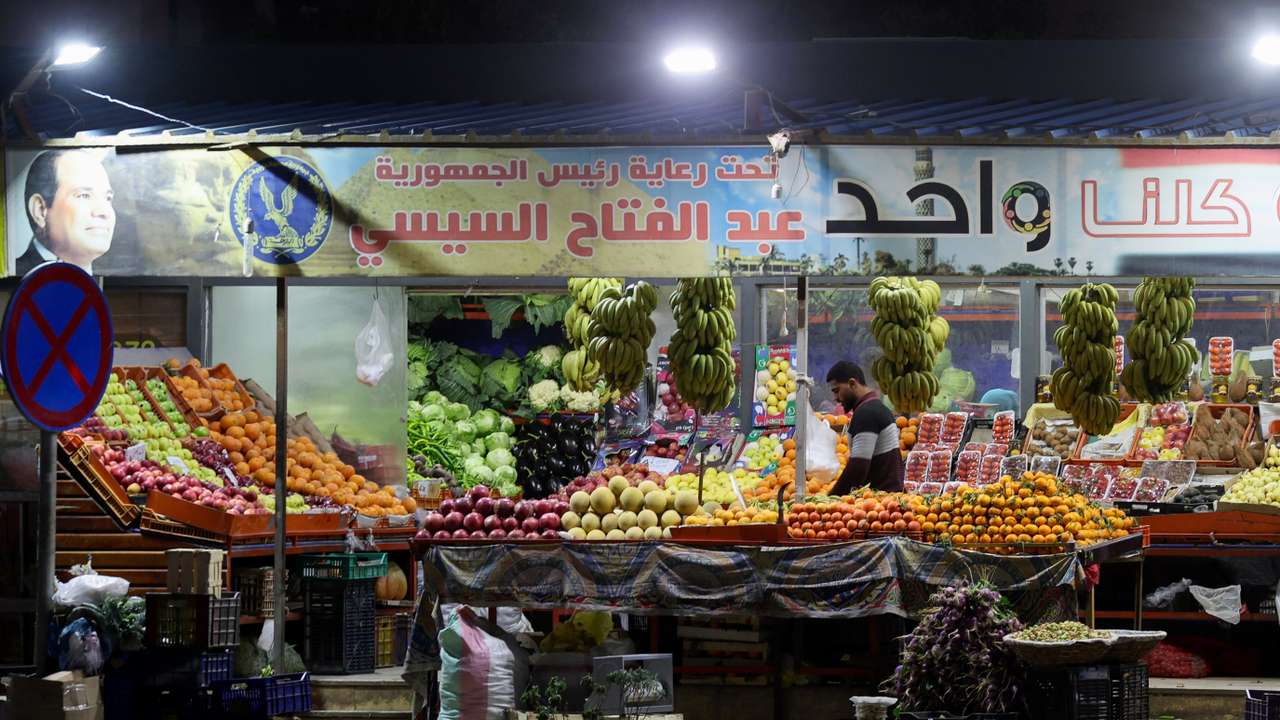 Egyptians buy food in a popular market in Cairo