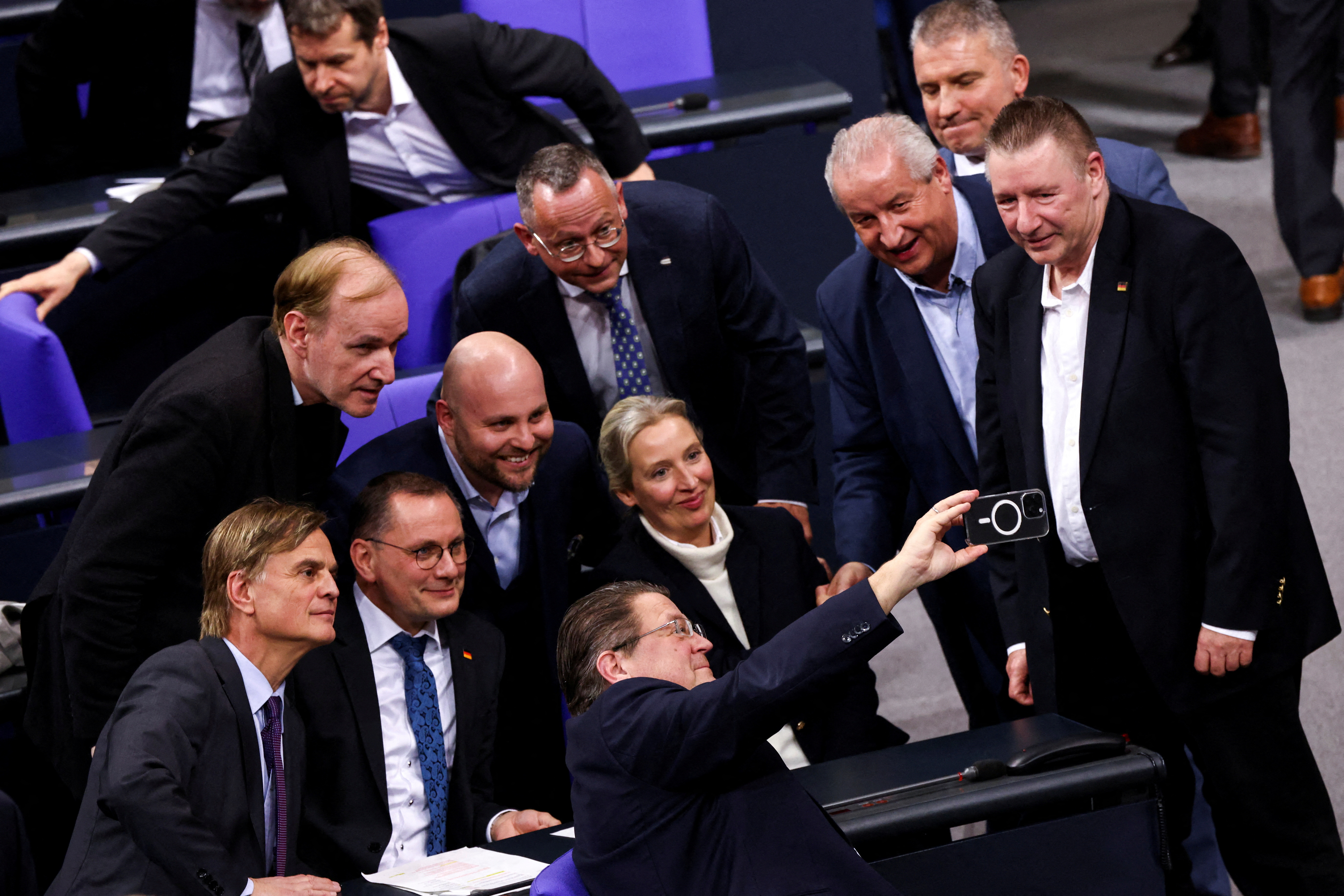 Members of the Alternative for Germany party (AfD) react following a vote in Berlin