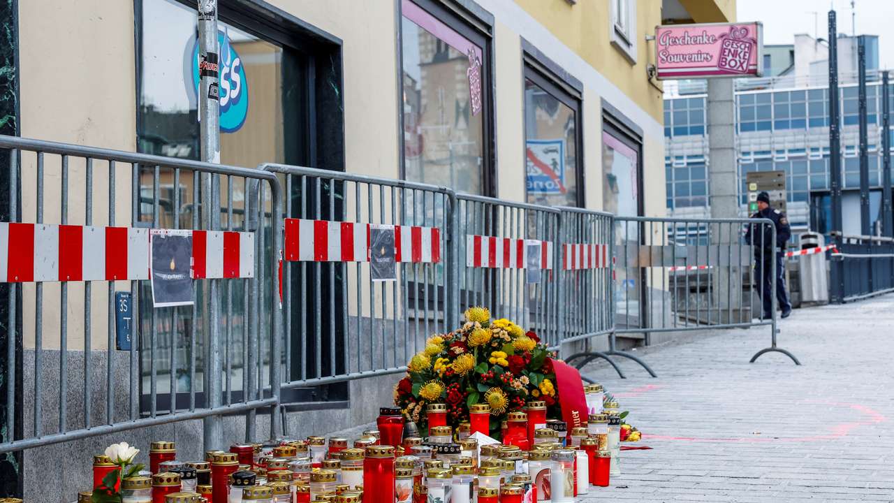 Candles and flowers sit at the scene where a 14-year-old boy was killed and several others were wounded in a stabbing attack, in the town of Villach