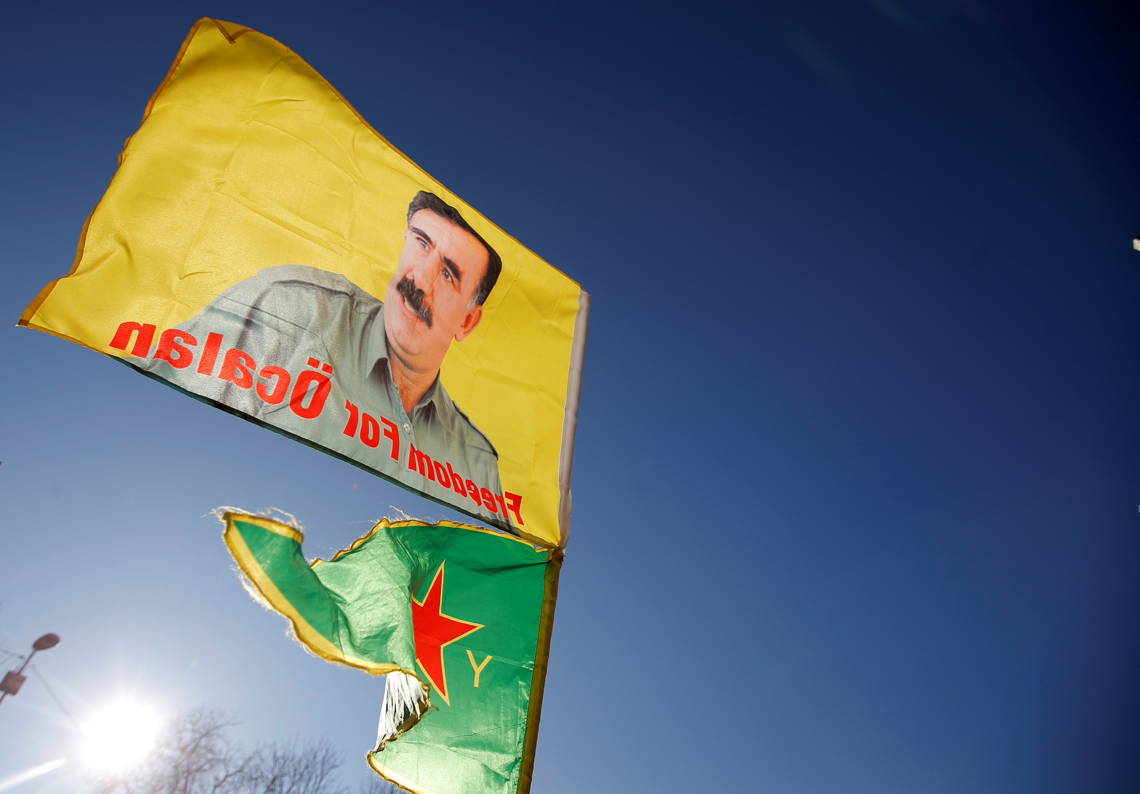 Pro-Kurd protesters hold flags with portraits of jailed PKK leader Ocalan as they take part in a demonstration in support to him in Strasbourg