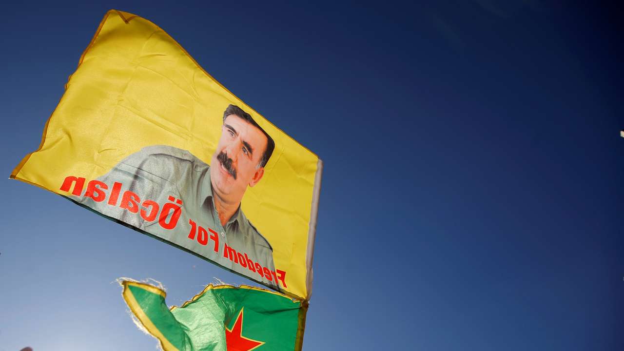 Pro-Kurd protesters hold flags with portraits of jailed PKK leader Ocalan as they take part in a demonstration in support to him in Strasbourg