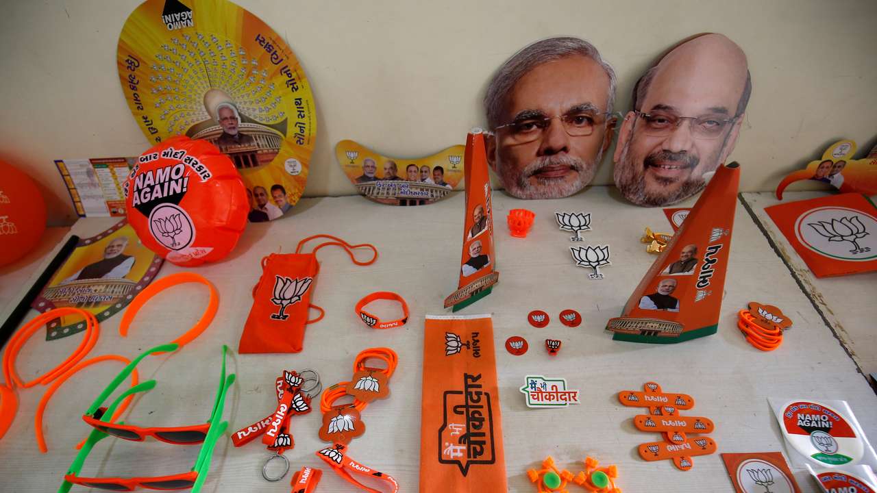 Wristbands, key chains and badges featuring India's ruling BJP and masks of the party president Shah and PM Modi are on display inside a BJP office ahead of general election, in Gandhinagar