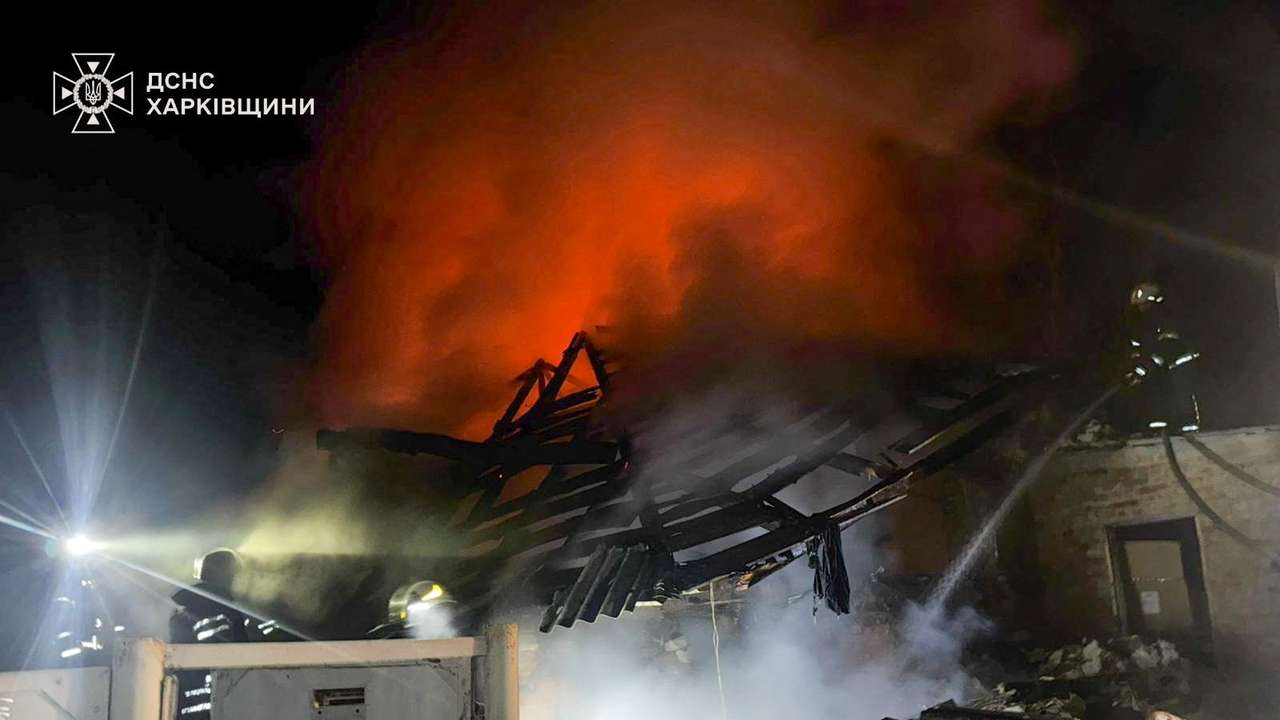 Firefighters work at the site of a house hit by a Russian drone strike in Kharkiv region