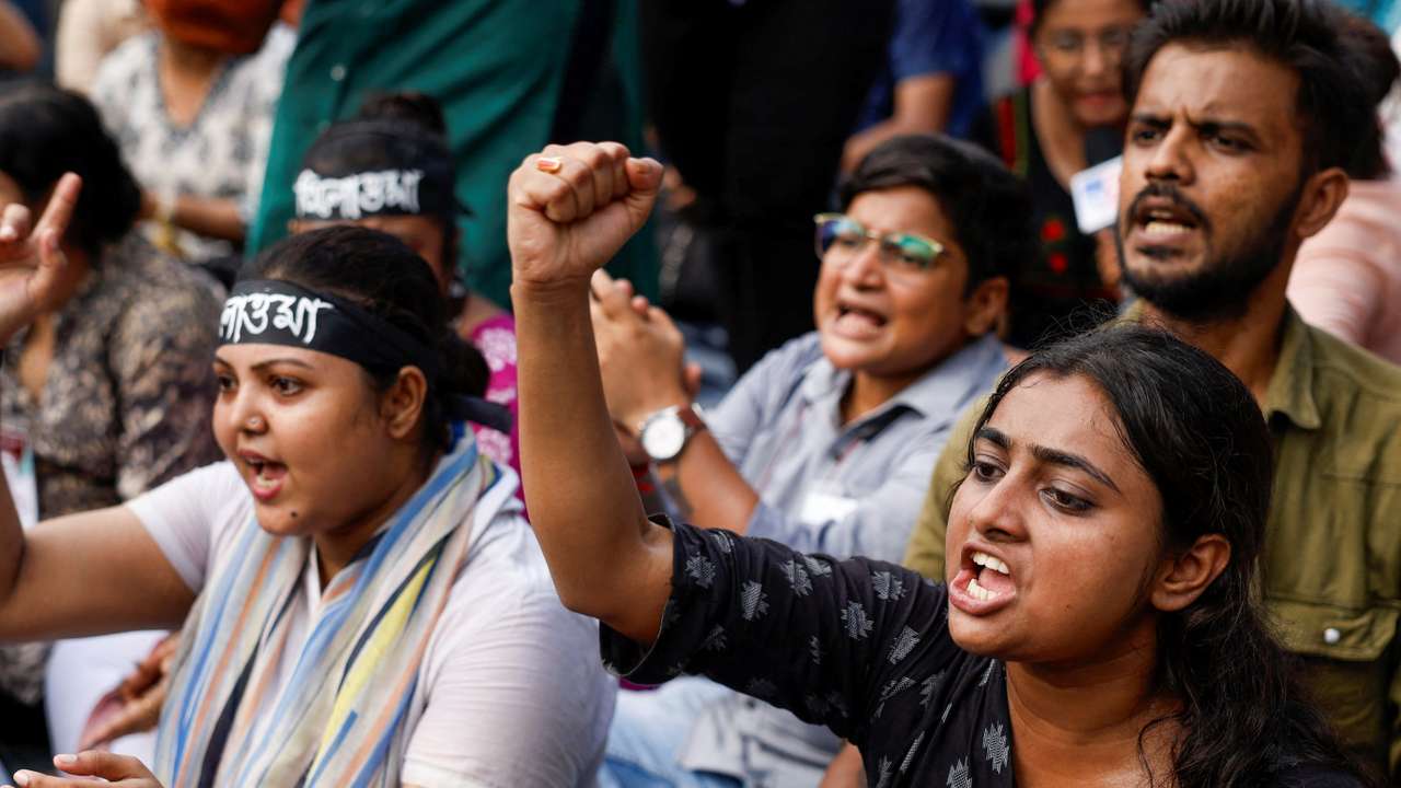 Medics sit and chant slogans as they attend a protest condemning the rape and murder of a trainee medic at a government-run hospital, in Kolkata