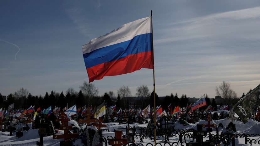 FILE PHOTO: Flags fly over the graves of Russian soldiers at a cemetery in Moscow region