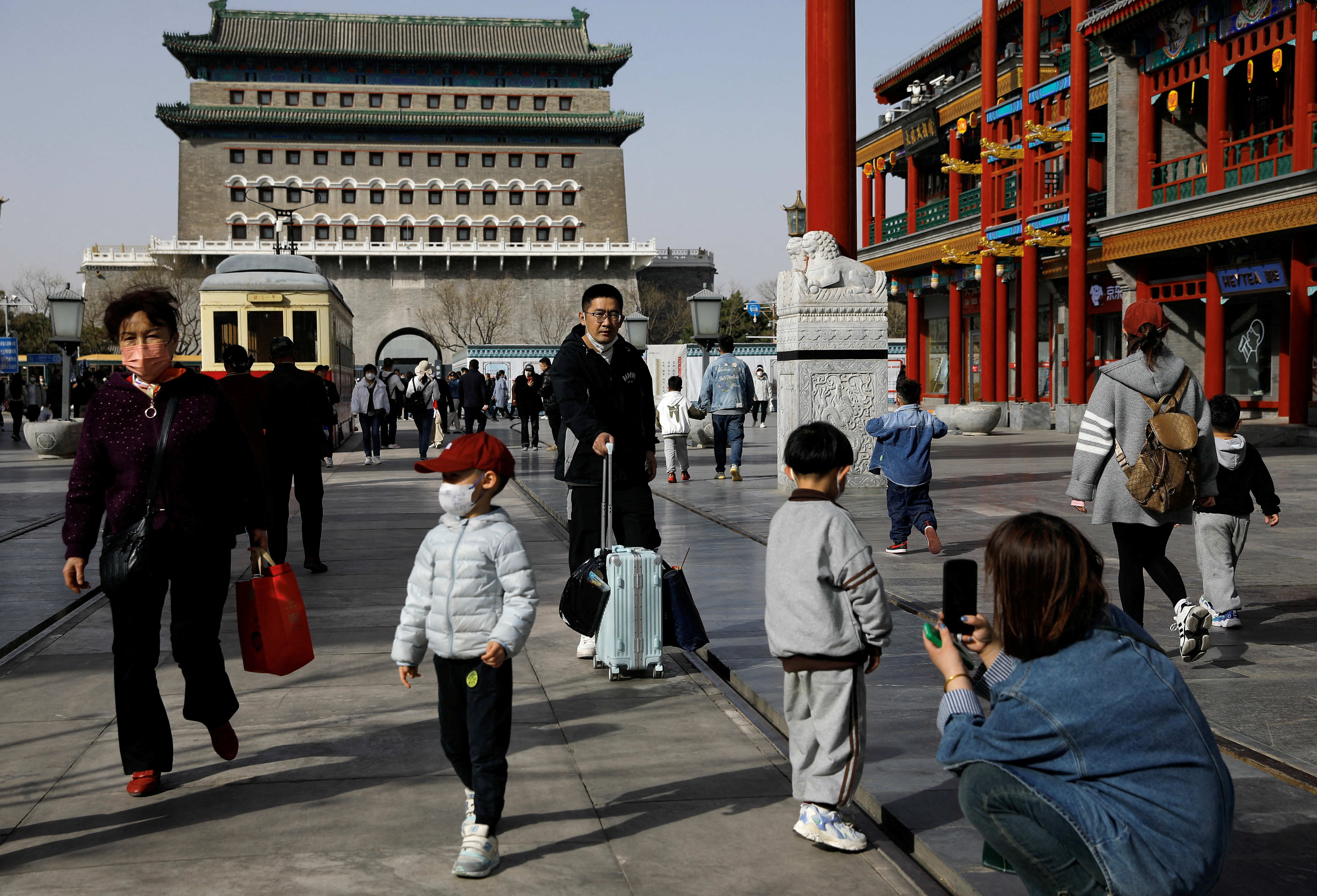 FILE PHOTO: People walk at a tourism site in Qianmen street, in Beijing,