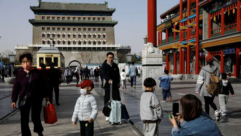 FILE PHOTO: People walk at a tourism site in Qianmen street, in Beijing,