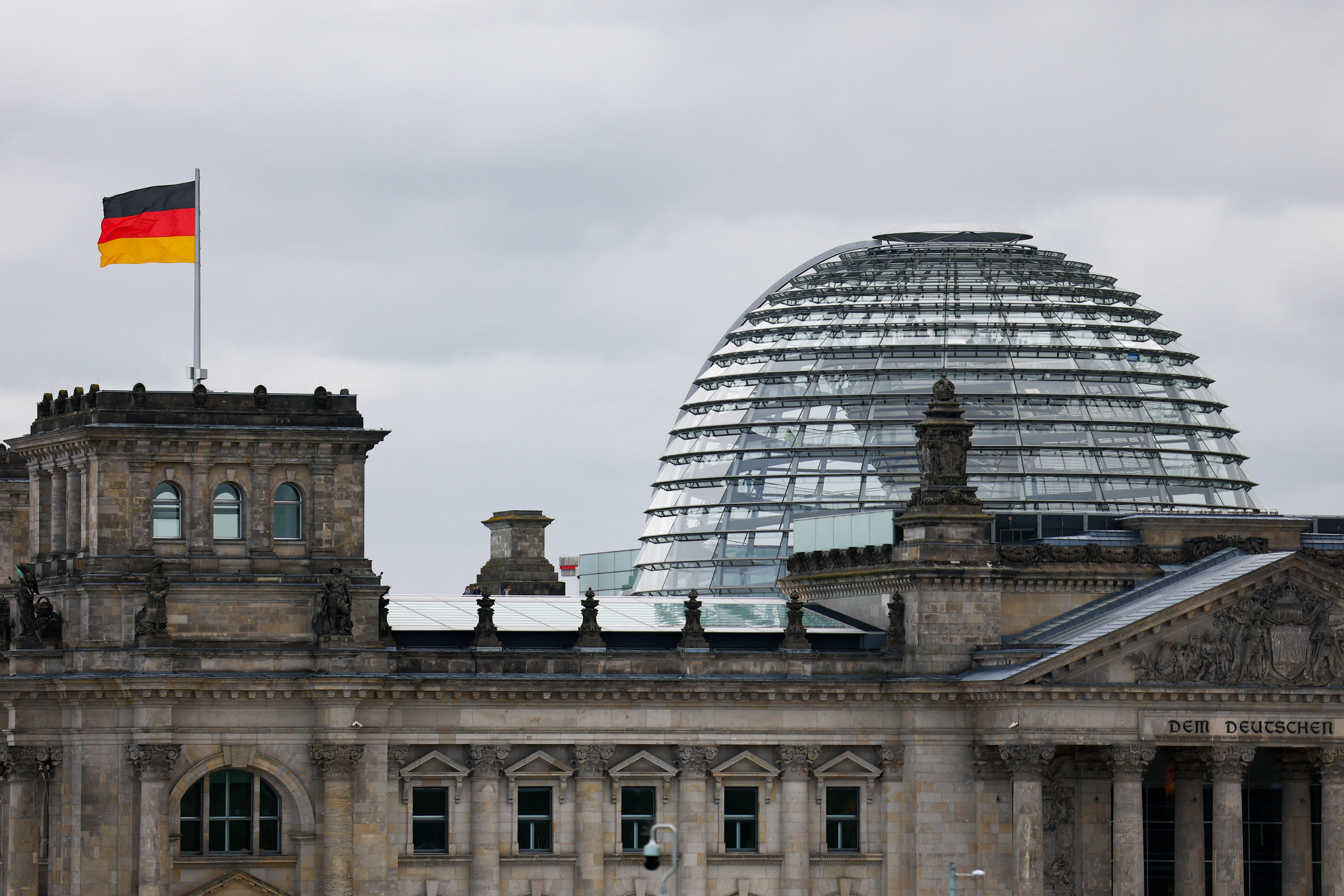 The German flag flutters outside the Reichstag building, the seat of the German parliament, the Bundestag, in Berlin