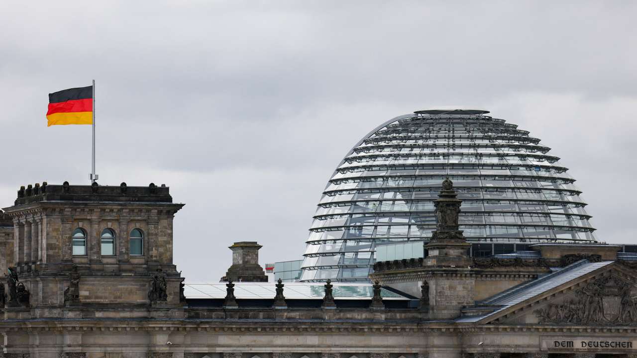 The German flag flutters outside the Reichstag building, the seat of the German parliament, the Bundestag, in Berlin