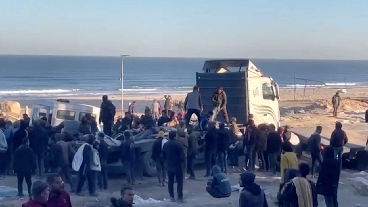 Palestinians with casualties following what Palestinian health officials said was Israeli fire on people waiting for aid, in Gaza City