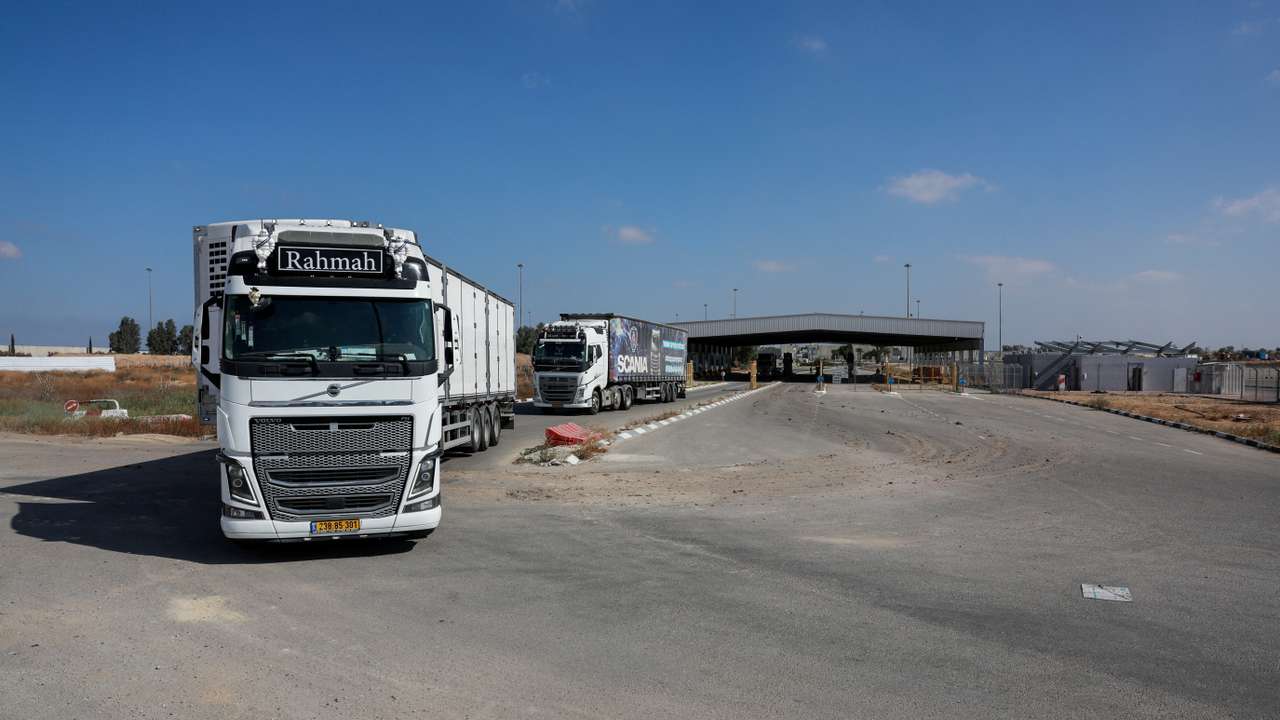 Trucks carrying aid drive at the Kerem Shalom crossing between Israel and Gaza, before going into Gaza, on the Israeli side of the Israel-Gaza border
