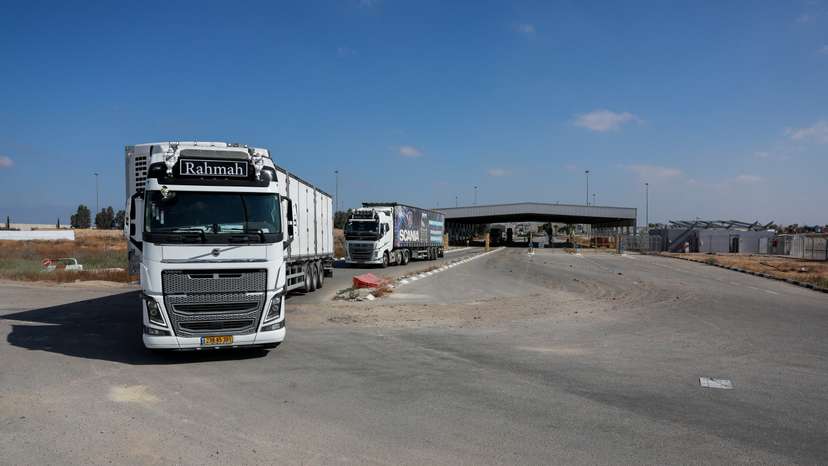 Trucks carrying aid drive at the Kerem Shalom crossing between Israel and Gaza, before going into Gaza, on the Israeli side of the Israel-Gaza border