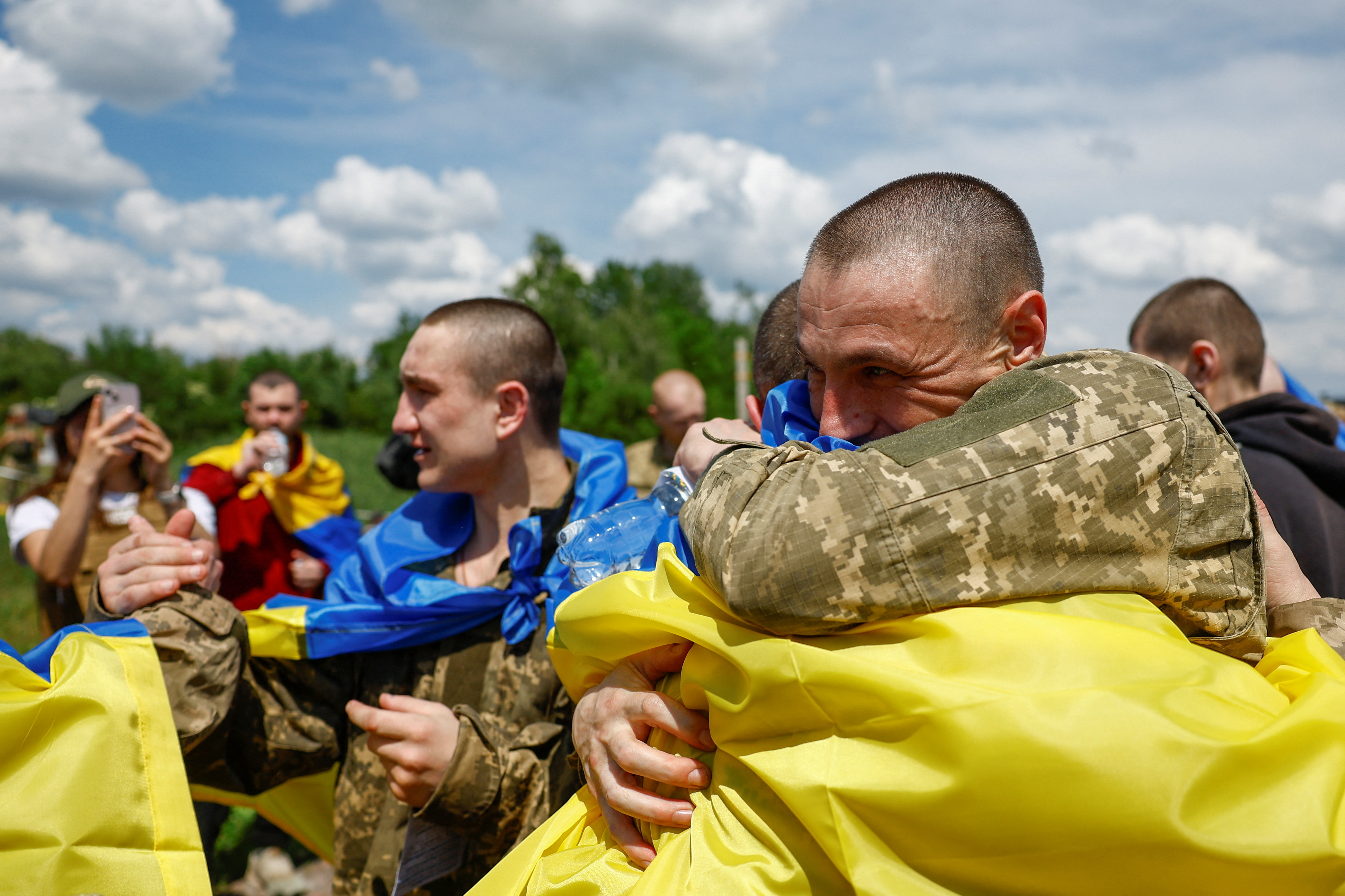 Ukrainian POWs react after a swap at an undisclosed location in Ukraine
