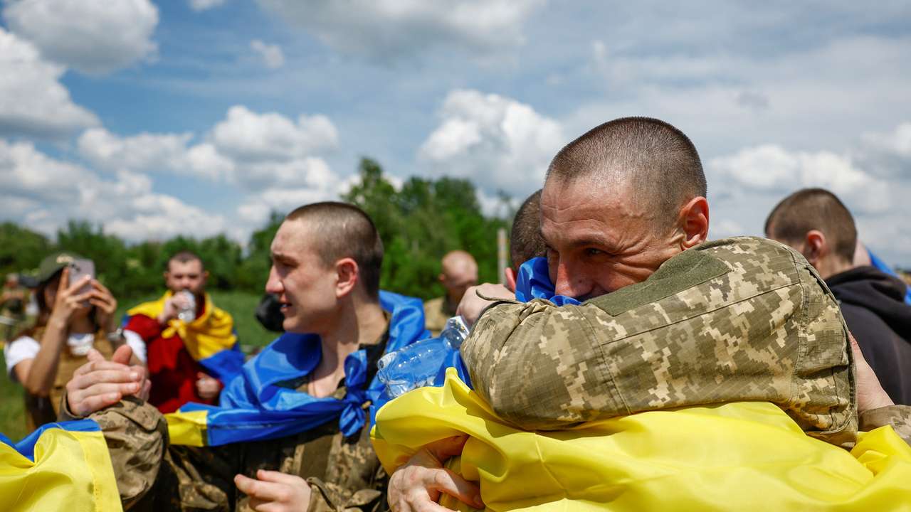 Ukrainian POWs react after a swap at an undisclosed location in Ukraine