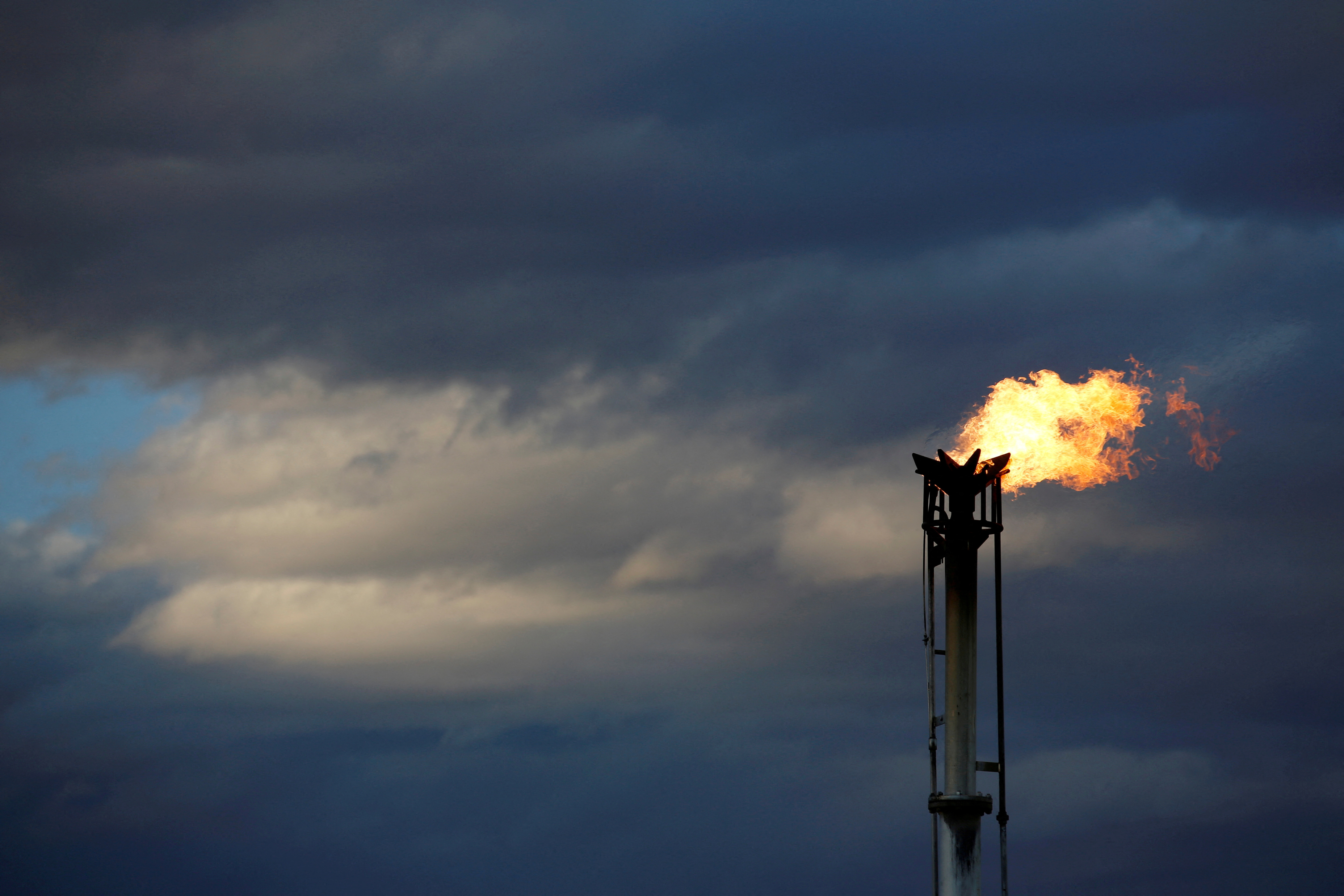 FILE PHOTO: A flare burns off excess gas from a gas plant in the Permian Basin in Loving County