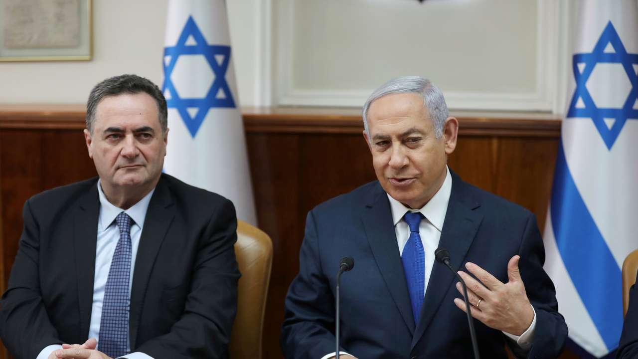 Israeli Prime Minister Benjamin Netanyahu sits next to acting foreign minister Israel Katz, who also serves as intelligence and transport minister, during the weekly cabinet meeting in Jerusalem