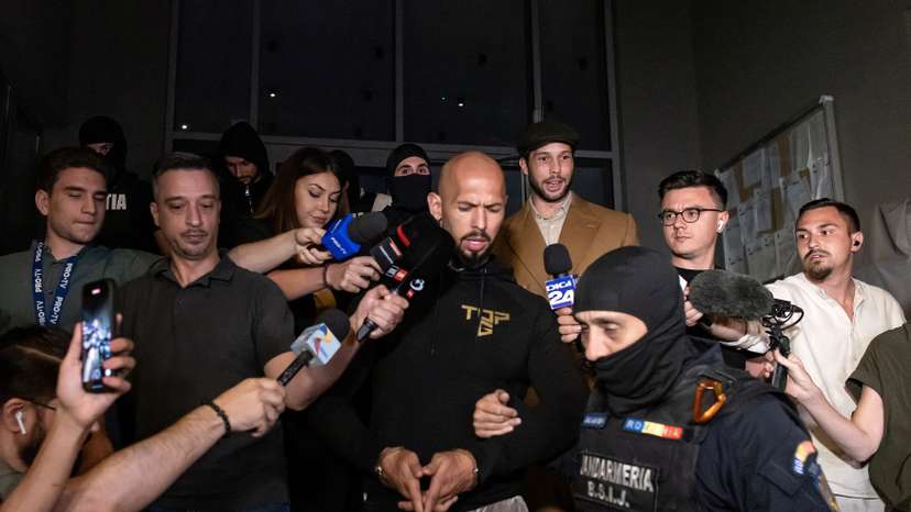 Andrew Tate and his brother Tristan are escorted outside the DIICOT in Bucharest