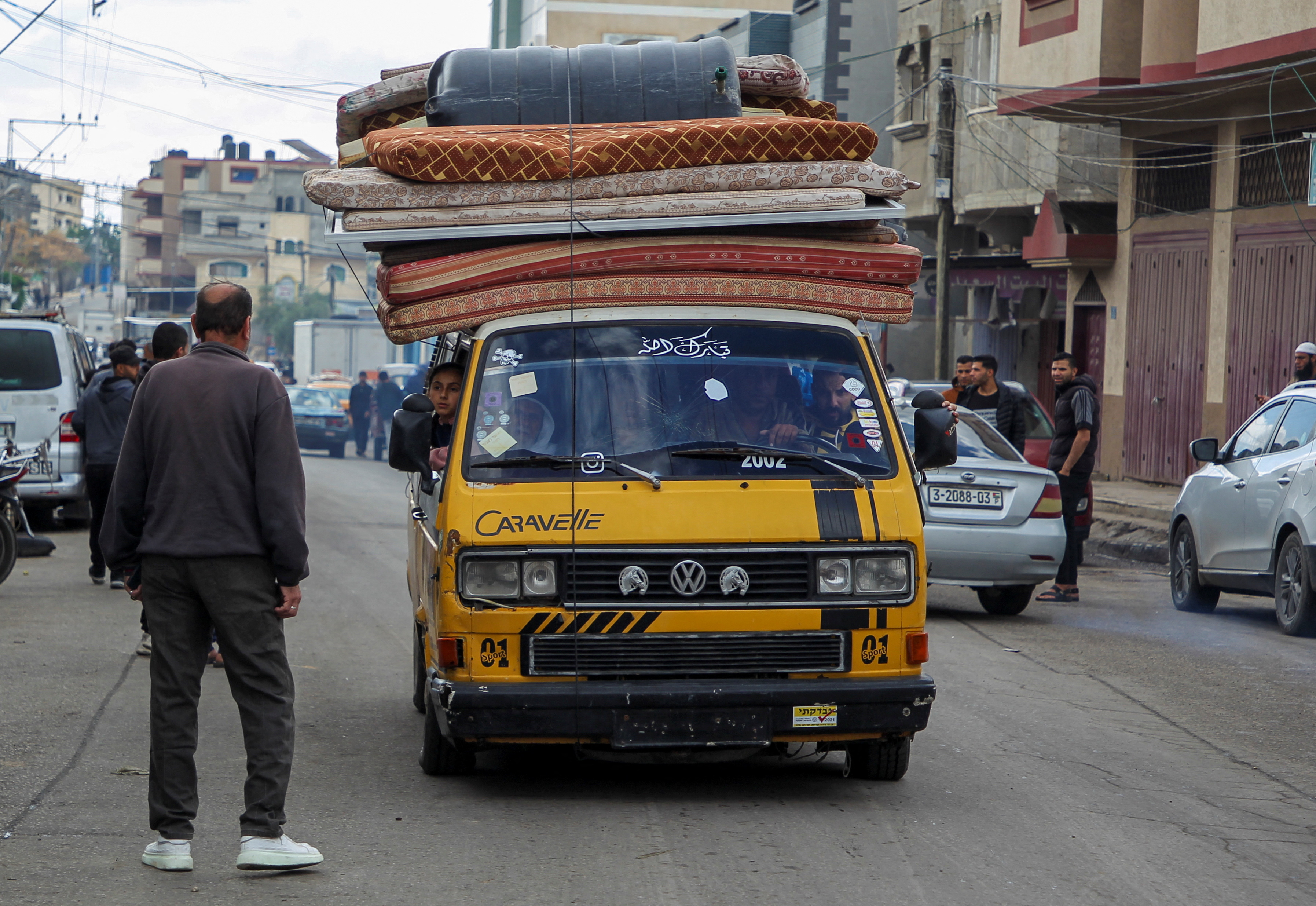 People flee the eastern parts of Rafah after the Israeli military began evacuating Palestinian civilians ahead of a threatened assault on the southern Gazan city