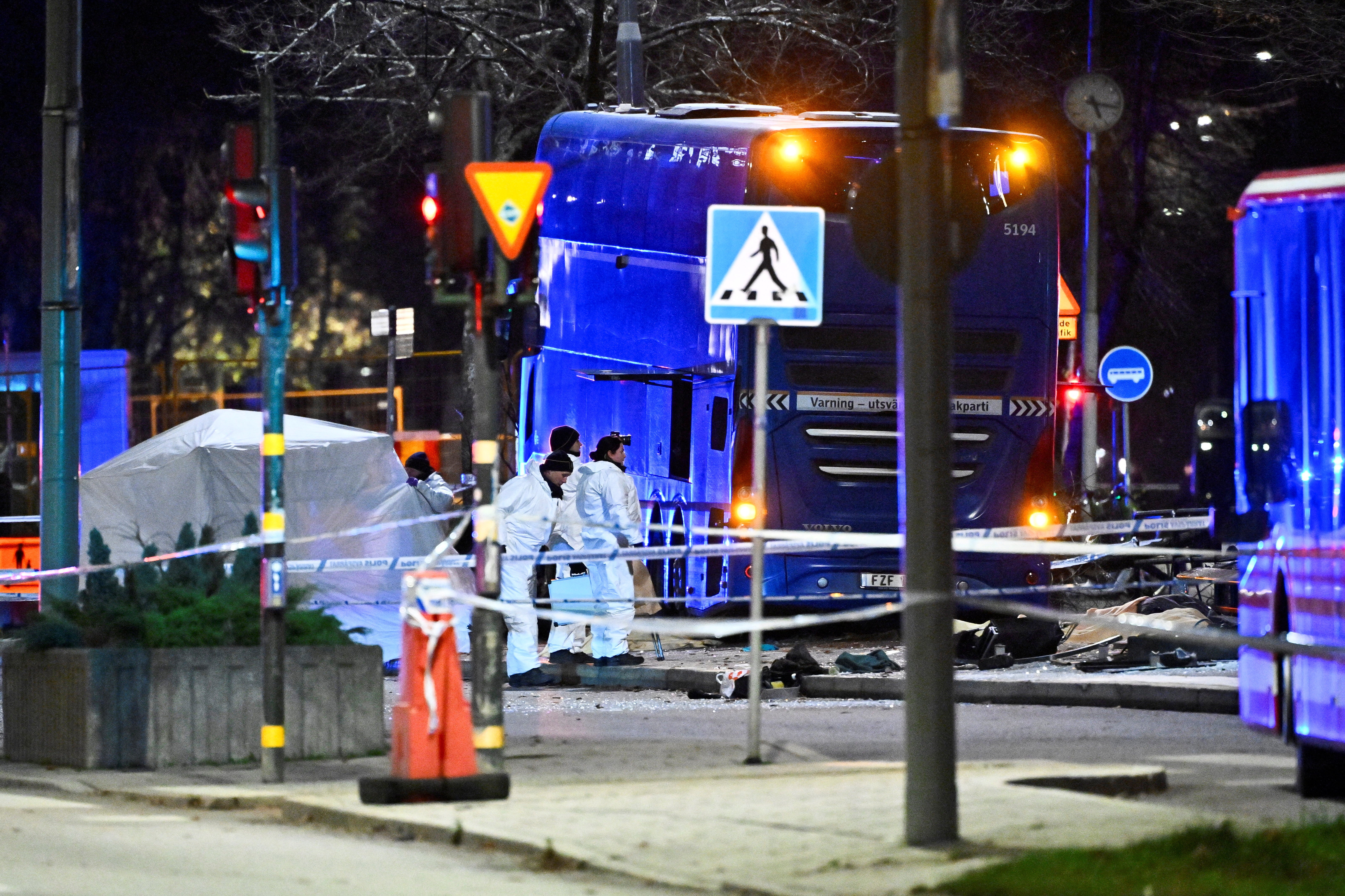 Emergency workers operate on site where a bus hit into a bus shelter in Ostermalm in Stockholm