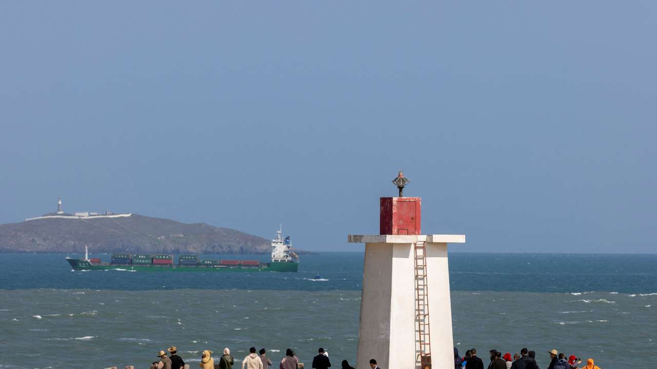 People look across the strait from a lighthouse at the 68-nautical-mile scenic spot, on Pingtan Island