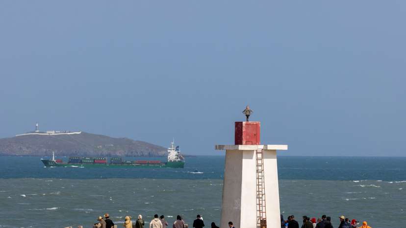 People look across the strait from a lighthouse at the 68-nautical-mile scenic spot, on Pingtan Island