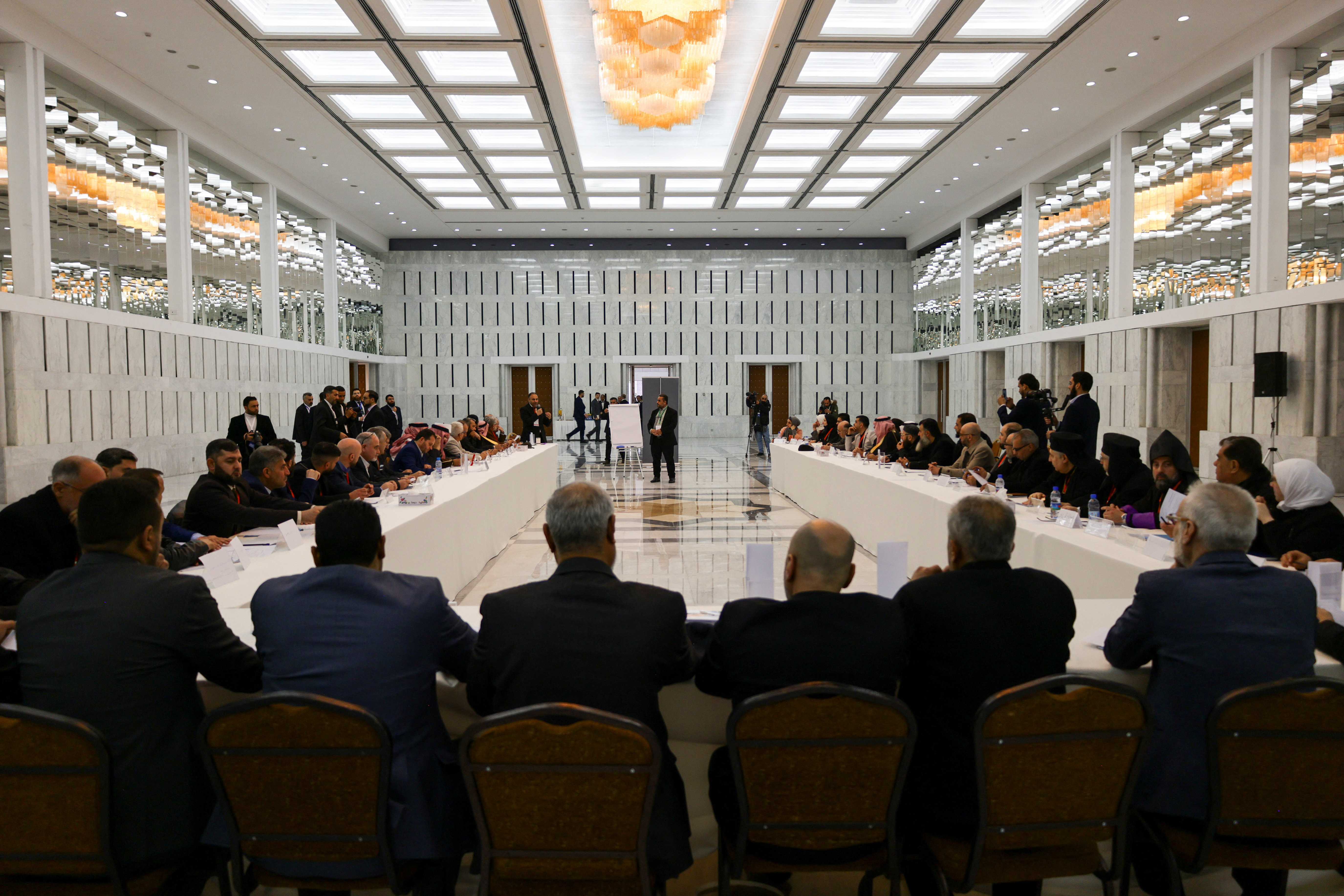 Attendees take part in a national dialogue, a key milestone in the transition to a new political system after decades of Assad rule, in Damascus
