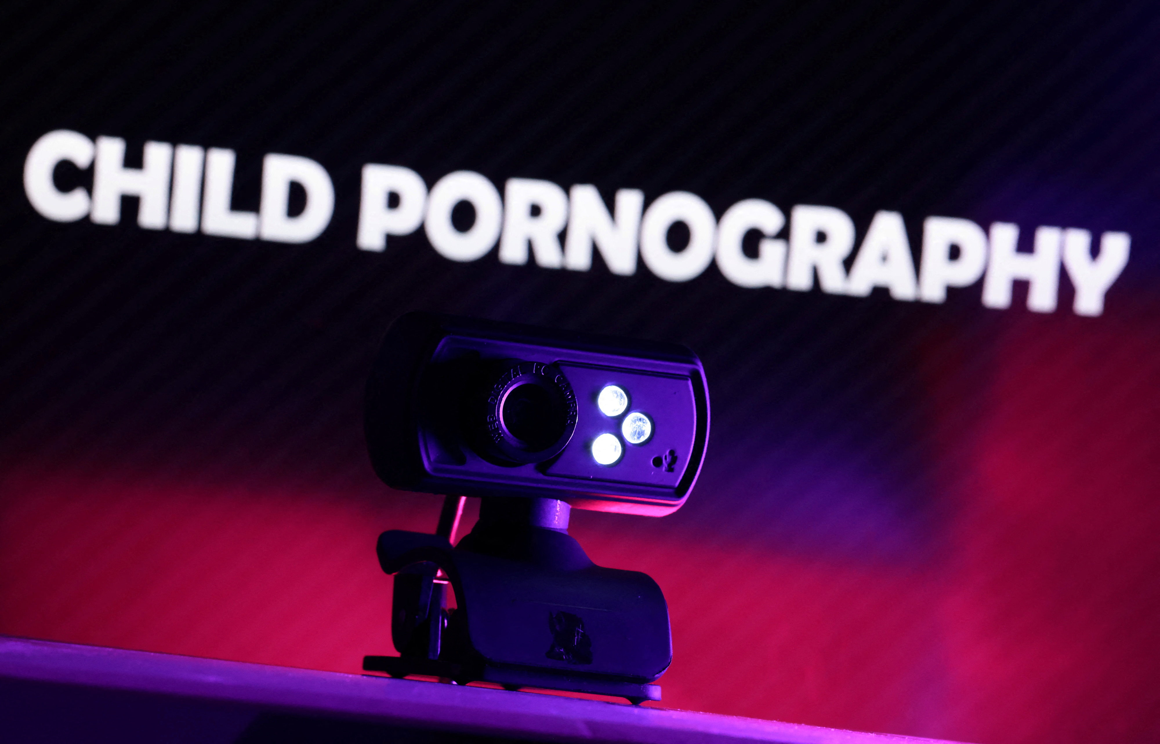 Illustration shows a web camera and displayed words "Child Pornography\