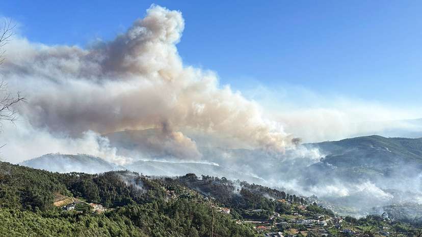 Smoke from a wildfire rises over the hills near the village of Canelas