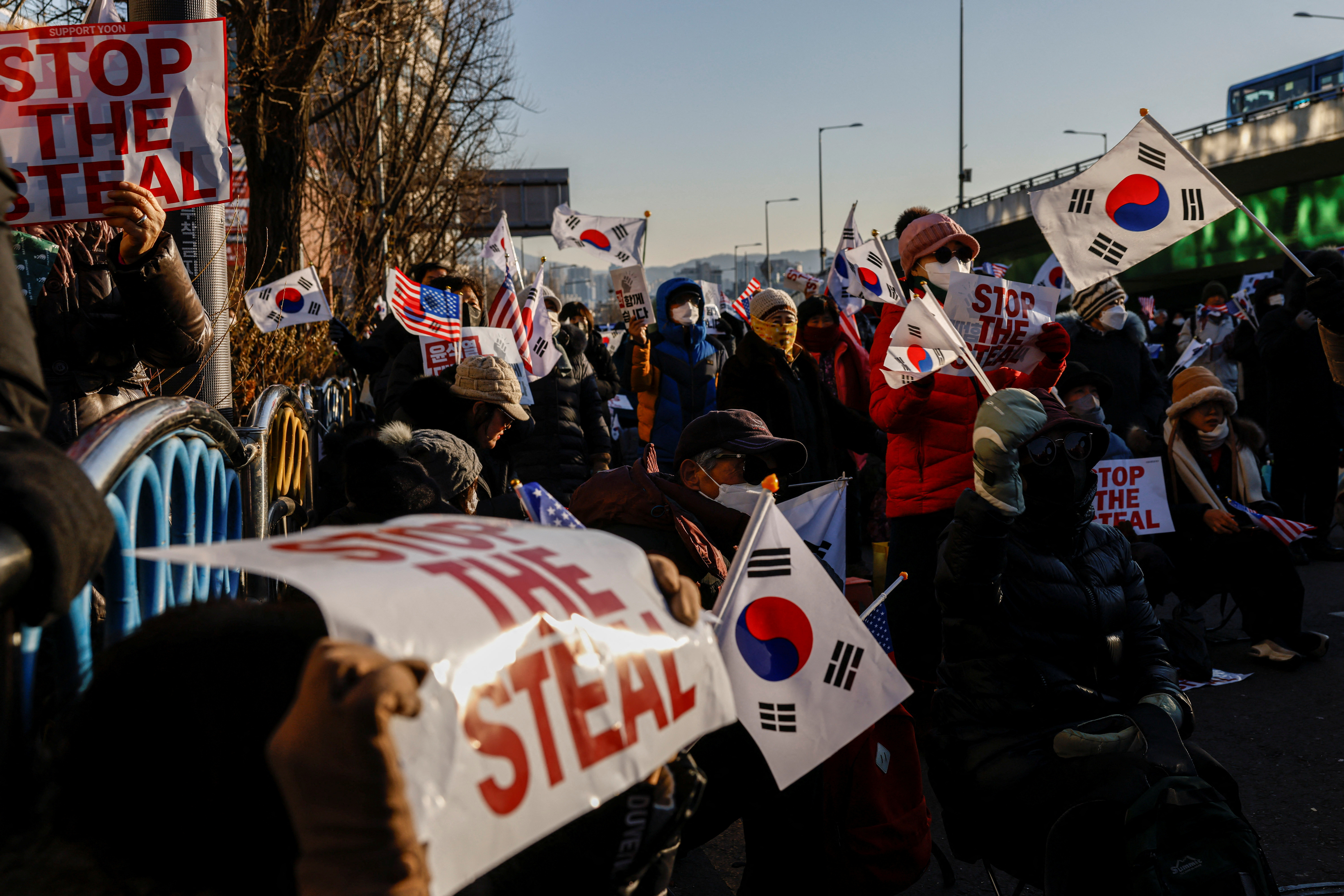 Pro-Yoon demonstrators hold U.S. and South Korean flags as they take part in a rally in support of impeached South Korean President Yoon Suk Yeol near his official residence in Seoul