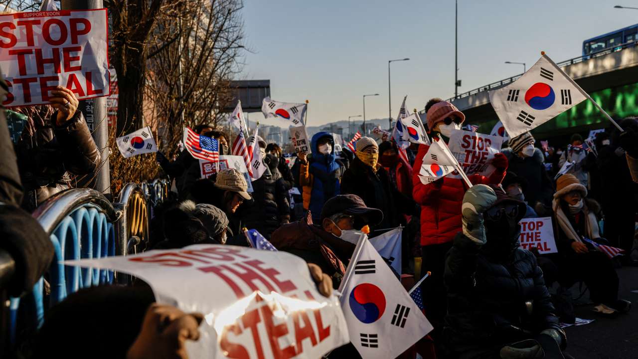 Pro-Yoon demonstrators hold U.S. and South Korean flags as they take part in a rally in support of impeached South Korean President Yoon Suk Yeol near his official residence in Seoul