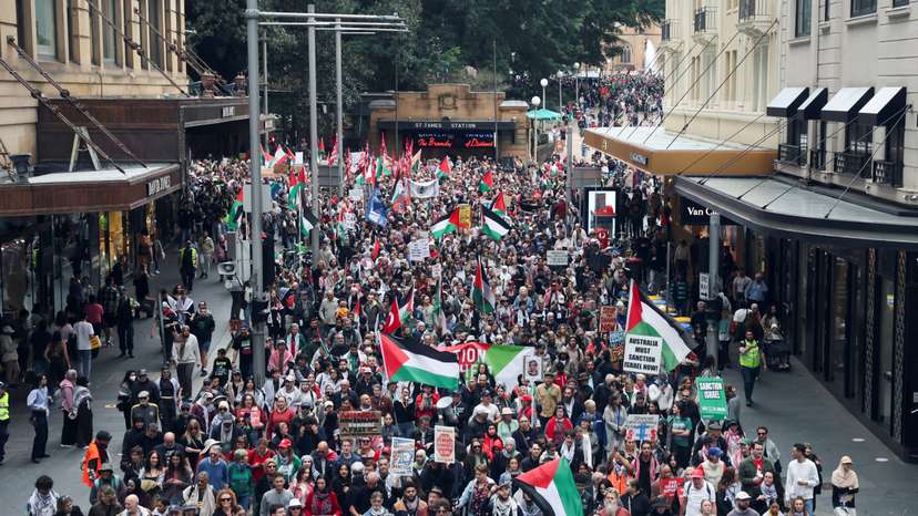 Demonstrators hold placards as they take part in the 'Nationwide March for Palestine' protest in Sydney