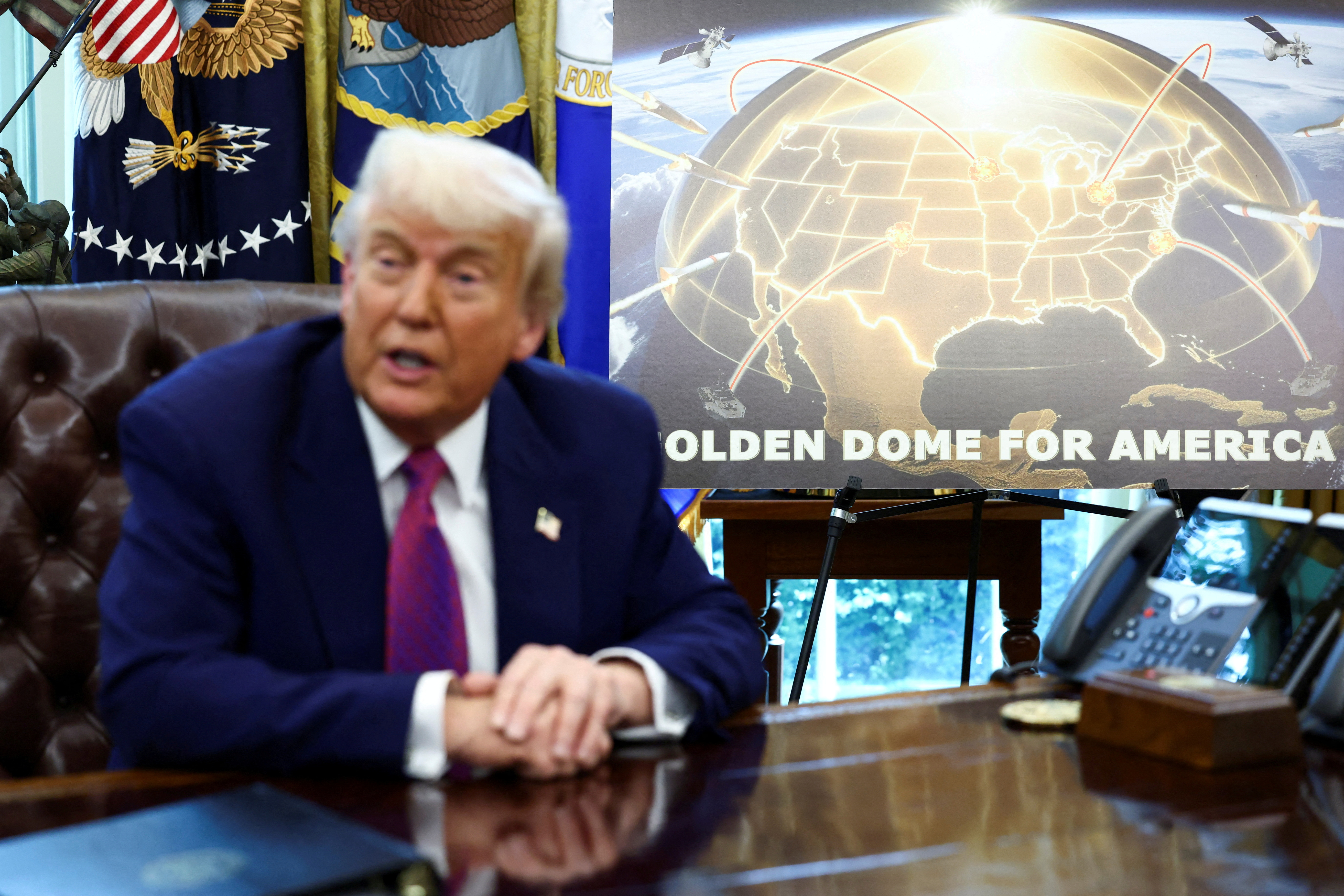 FILE PHOTO: U.S. President Donald Trump and U.S. Defense Secretary Pete Hegseth make an announcement at the White House in Washington