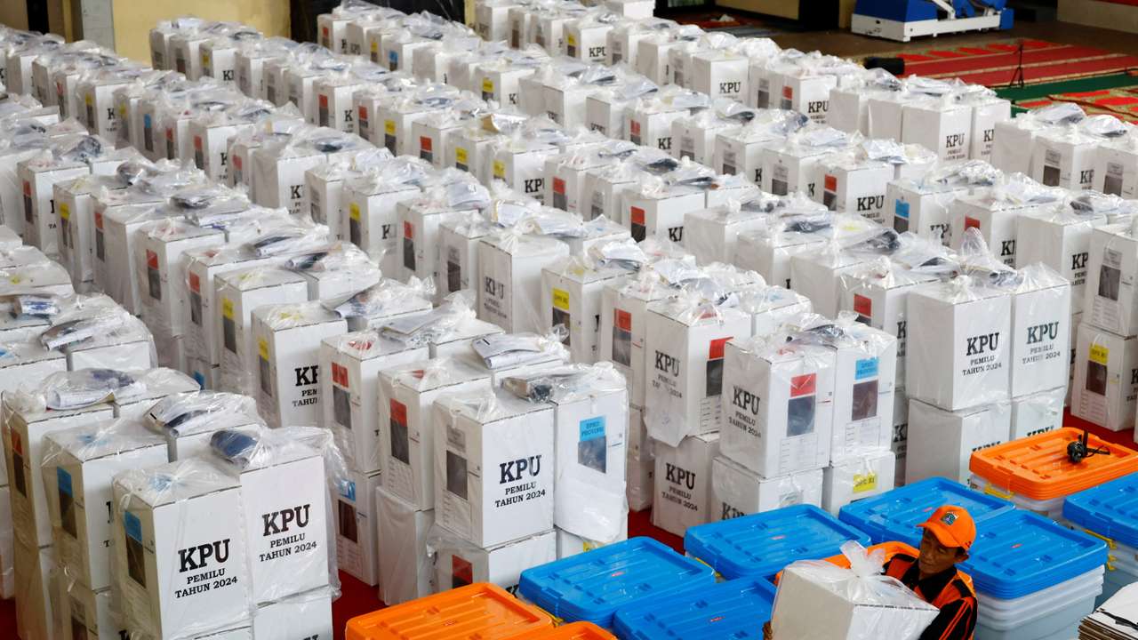 A worker carries a ballot box for distribution to polling stations at a distribution centre ahead of the presidential election in Jakarta