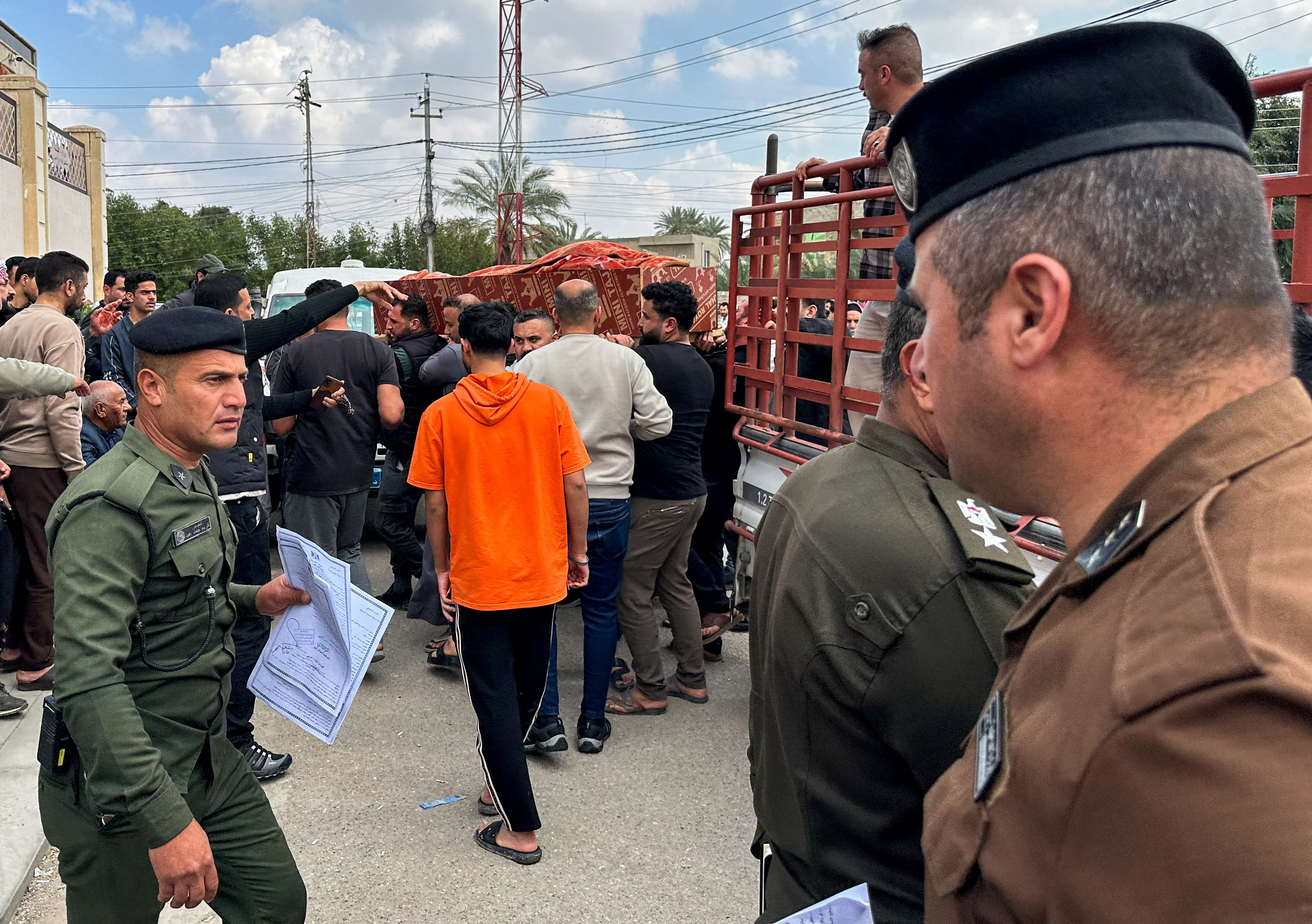 Relatives carry the coffin of an Iraqi soldier killed in an airstrike near an army medical centre in western Anbar, at the forensic medicine department of Ramadi General Hospital