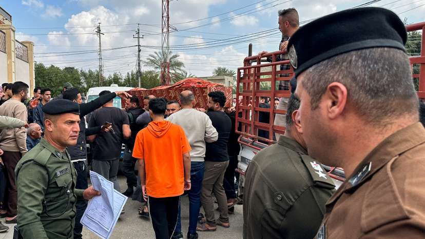 Relatives carry the coffin of an Iraqi soldier killed in an airstrike near an army medical centre in western Anbar, at the forensic medicine department of Ramadi General Hospital