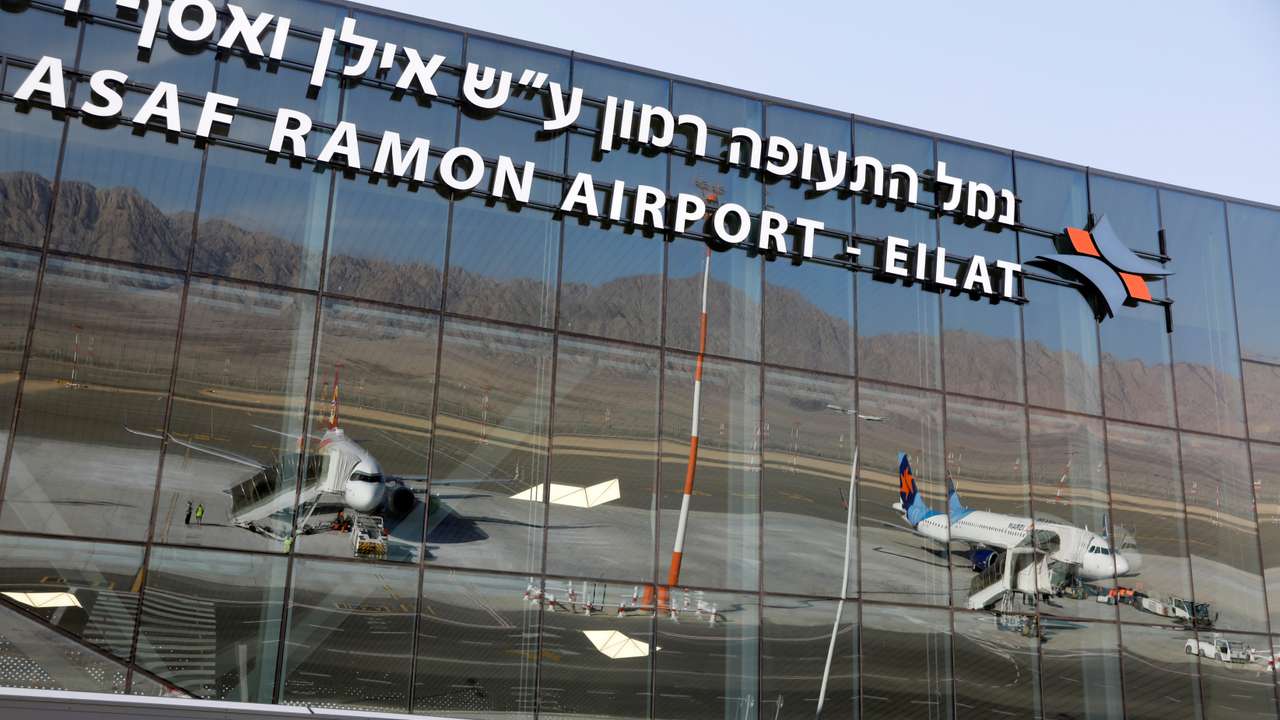 Planes are reflected in the facade of the Ramon International Airport after an inauguration ceremony for the new airport, just outside the southern Red Sea resort city of Eilat, Israel