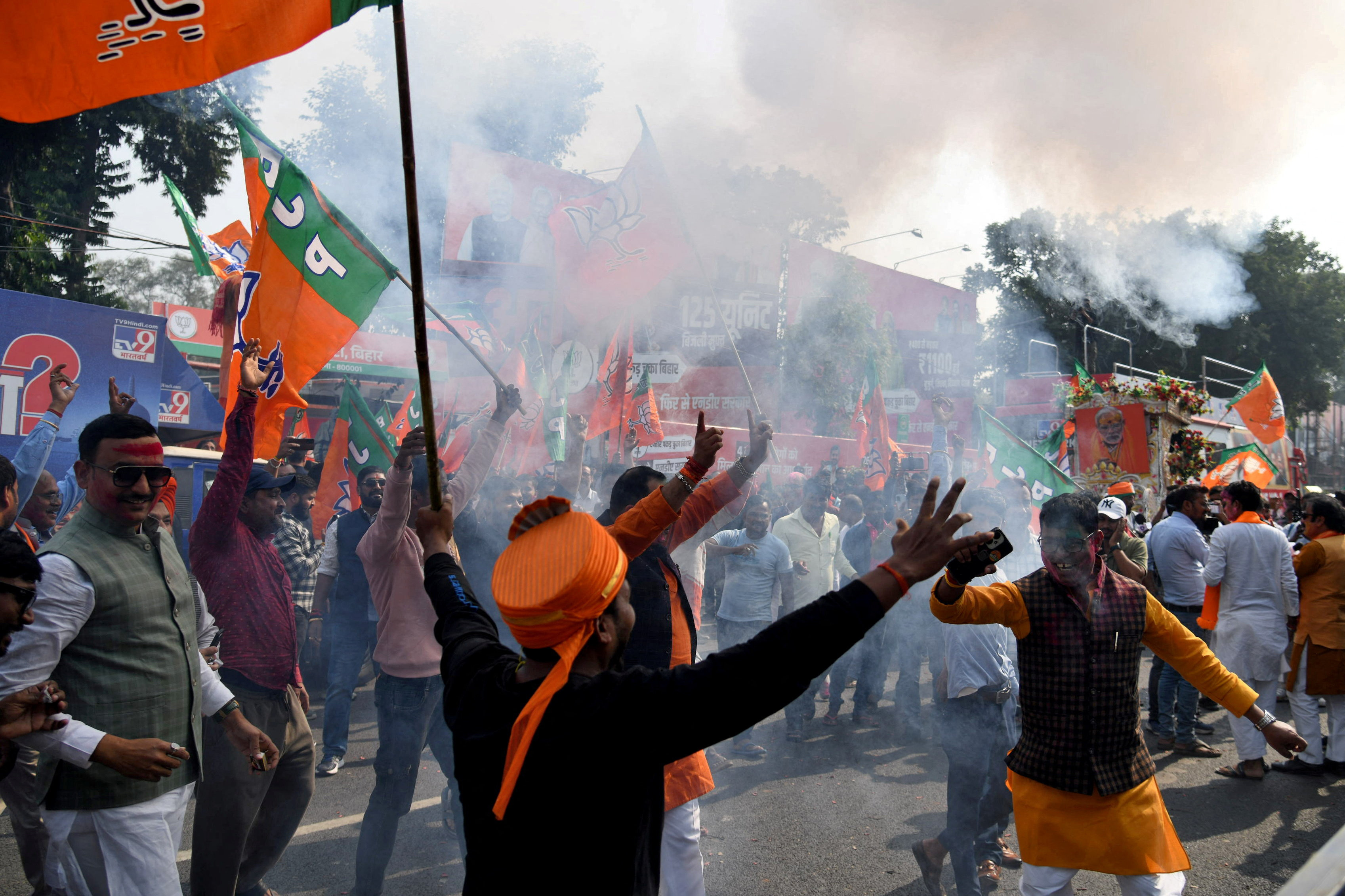 BJP supporters celebrate as early trends show the ruling National Democratic Alliance leading in the Bihar state assembly election results, in Patna