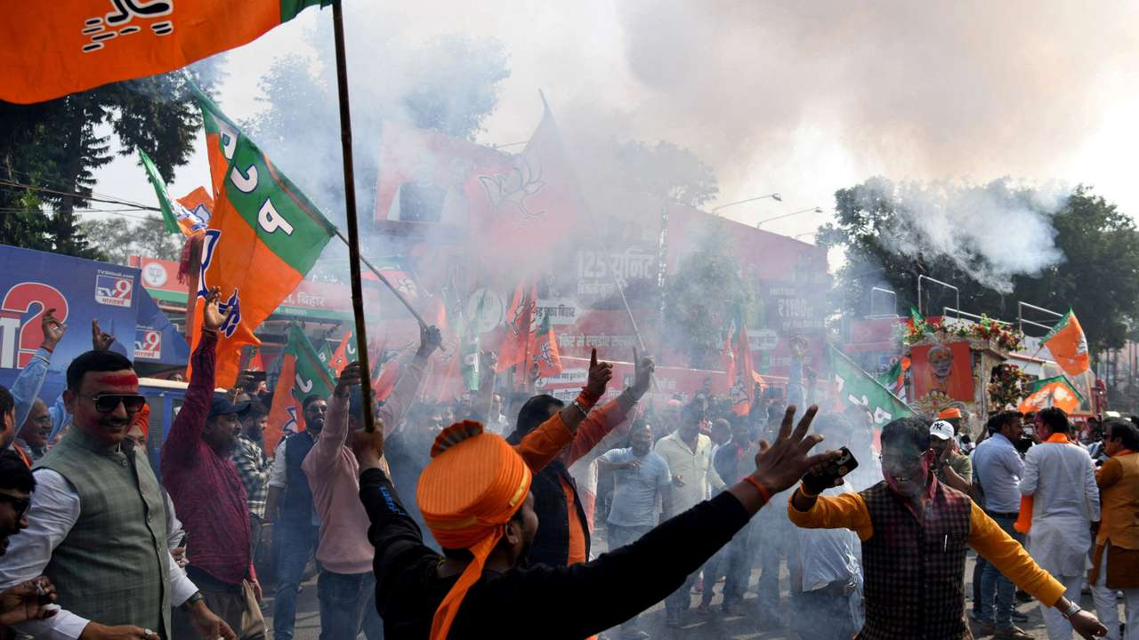 BJP supporters celebrate as early trends show the ruling National Democratic Alliance leading in the Bihar state assembly election results, in Patna