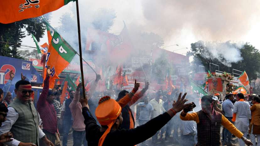 BJP supporters celebrate as early trends show the ruling National Democratic Alliance leading in the Bihar state assembly election results, in Patna