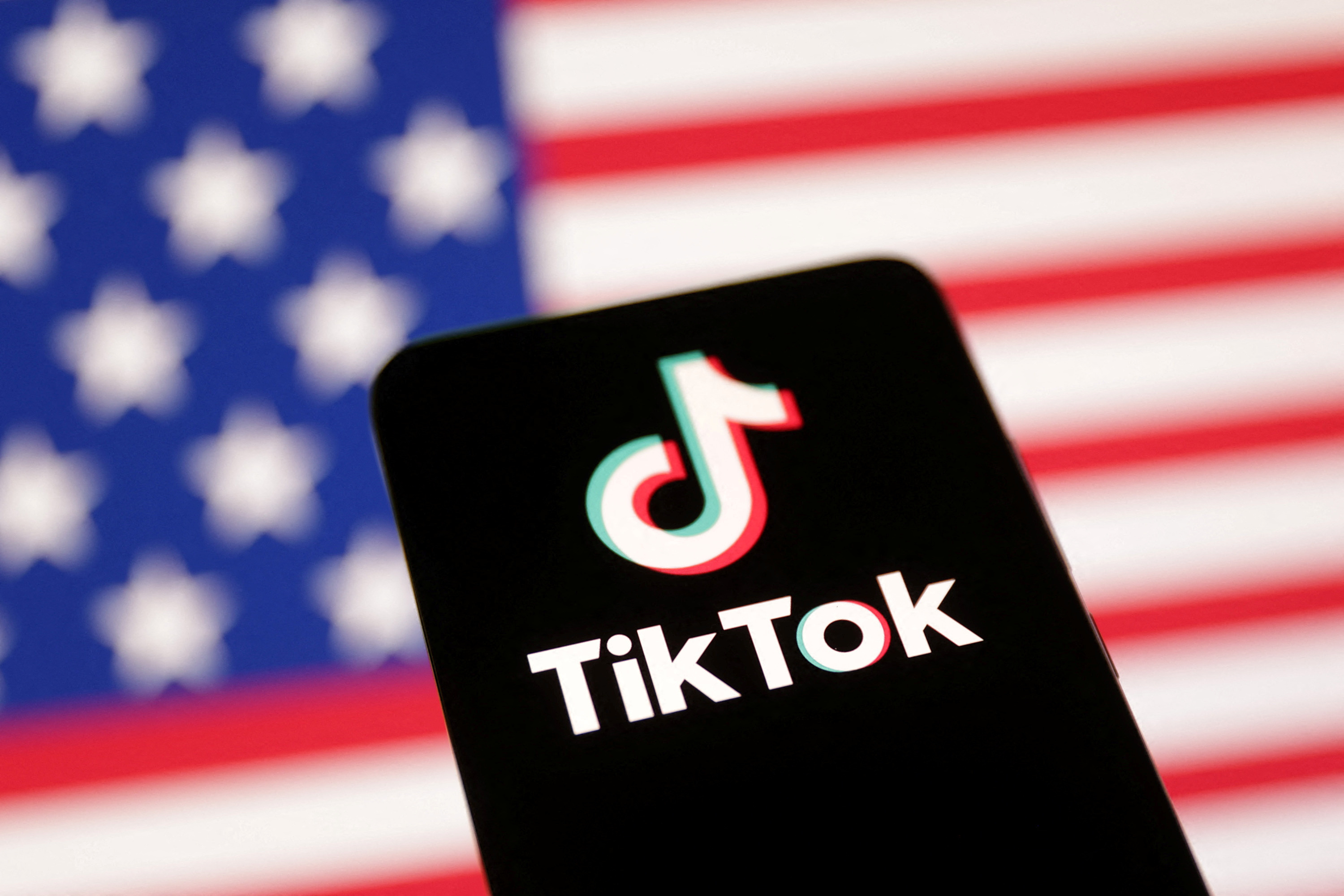Illustration shows U.S. flag and TikTok logo