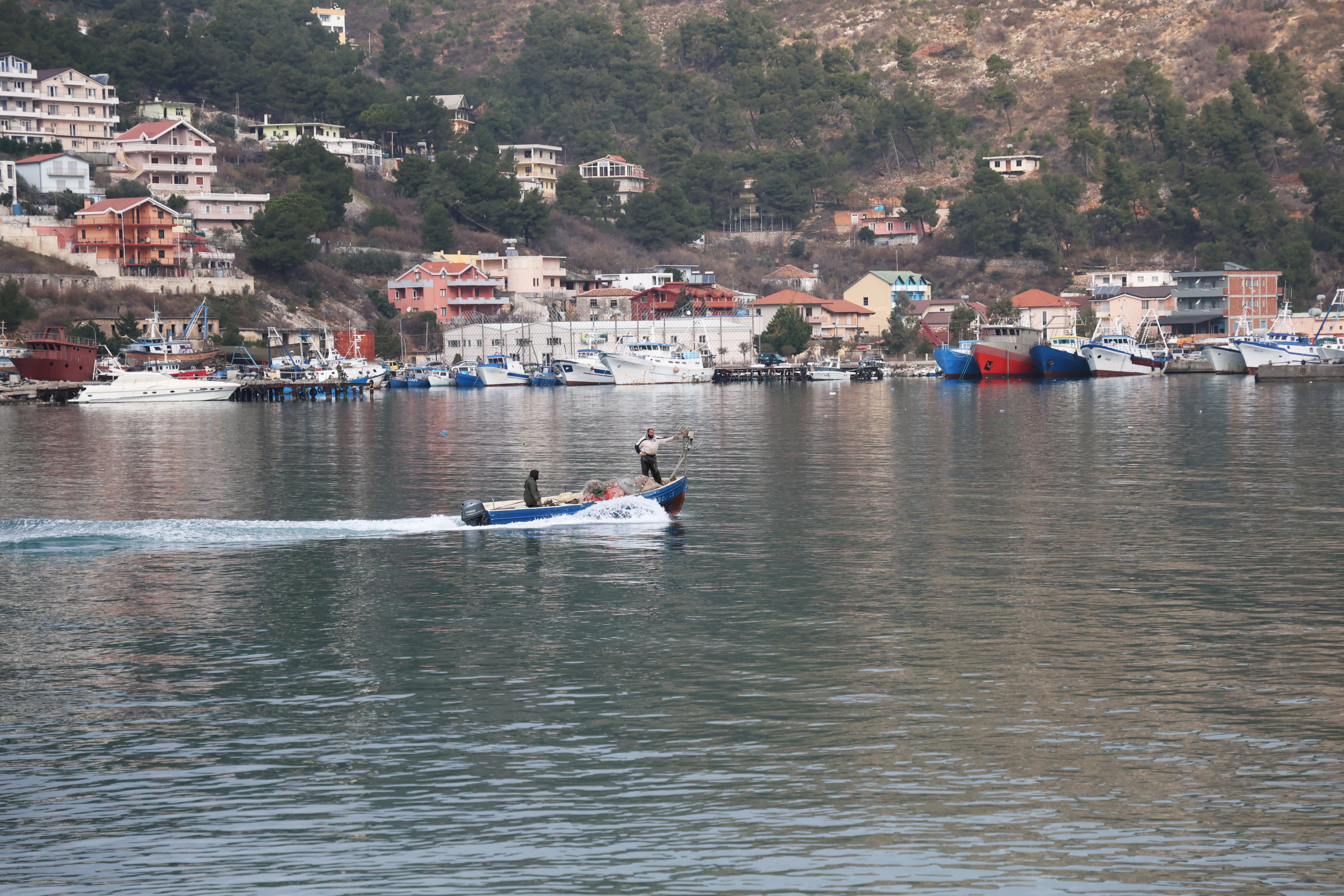 A fishing boat arrives at the port in Shengjin