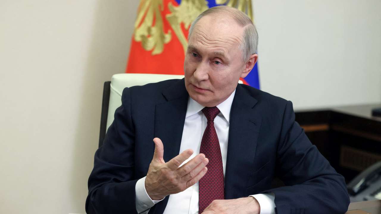 Russian President Putin speaks with correspondent Zarubin at his residence outside Moscow