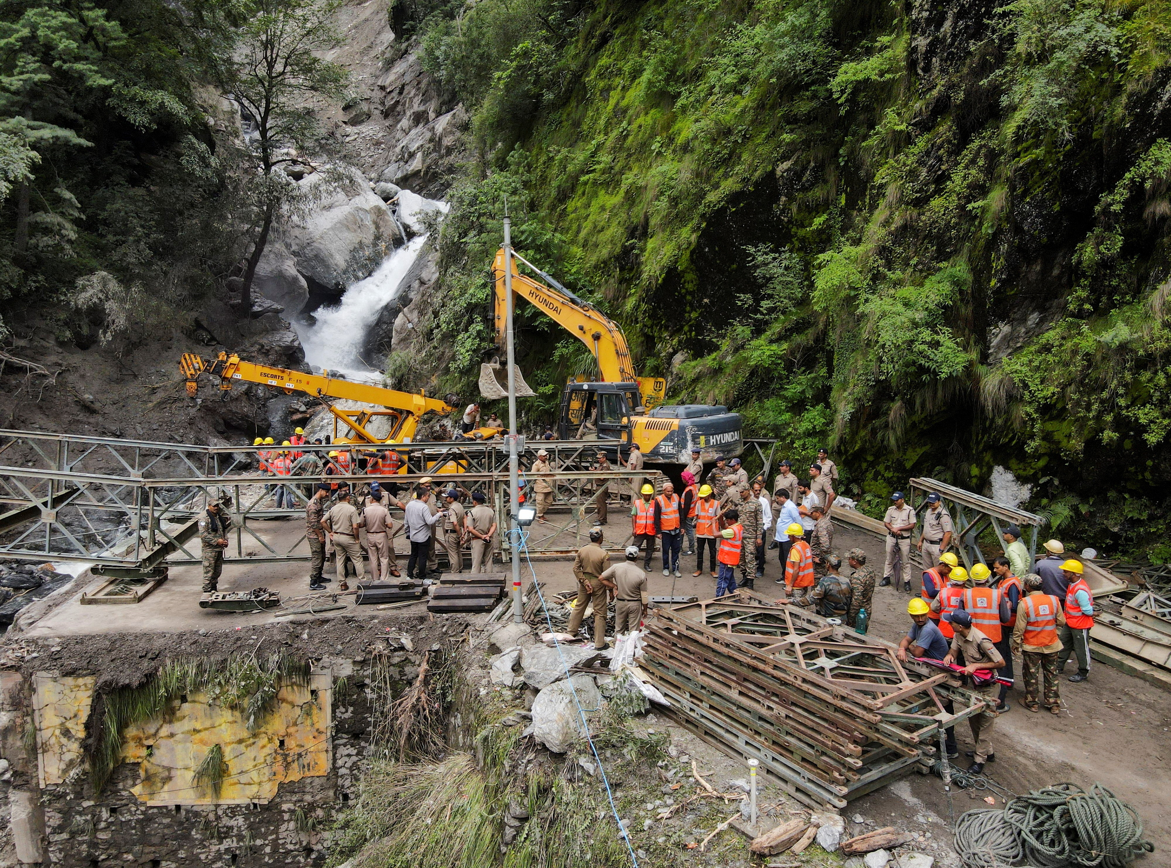 A drone view of BRO and SDRF officials attempting to build a makeshift bridge in Gangnani