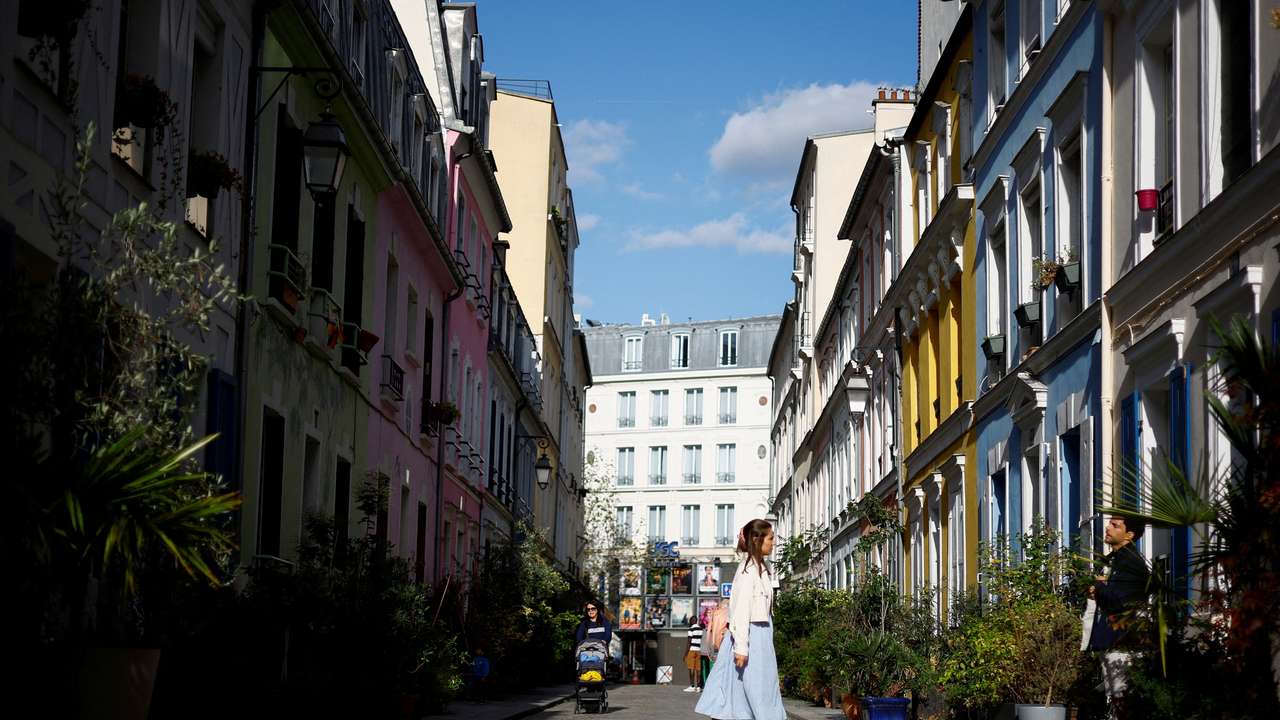 FILE PHOTO: People walk in Rue Cremieux in Paris
